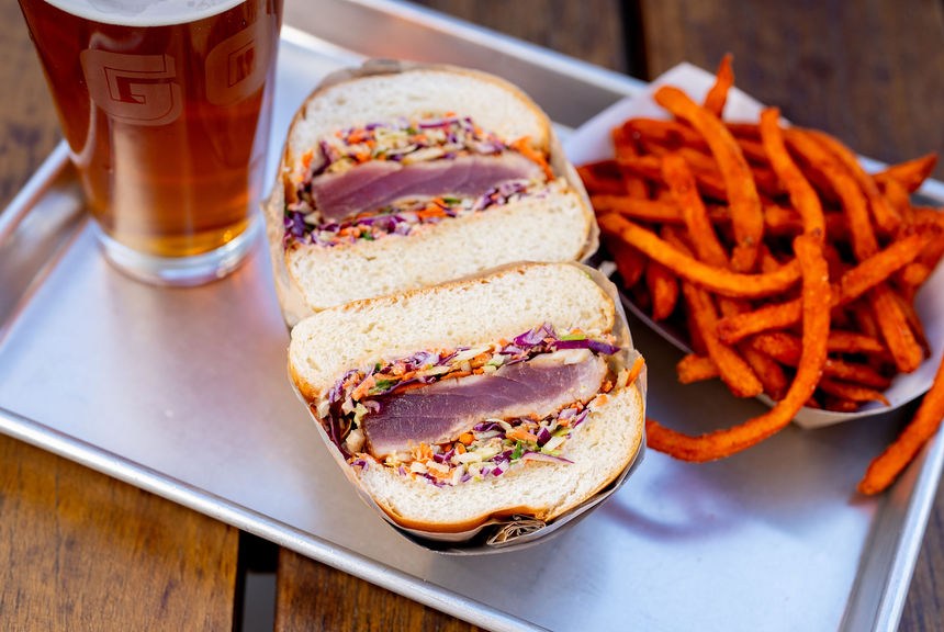 Ahi burger with slaw on a metal tray with sweet potato fries at Gott’s.