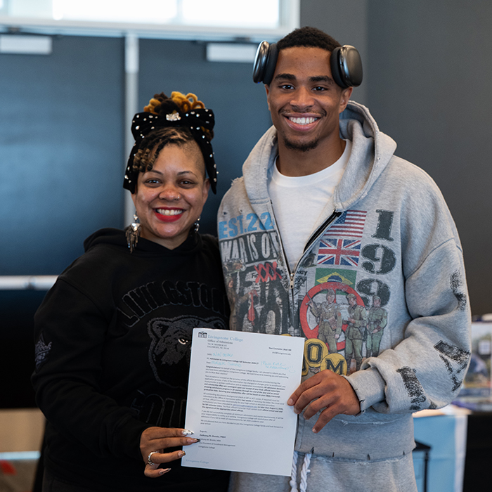 event attendee holding acceptance letter