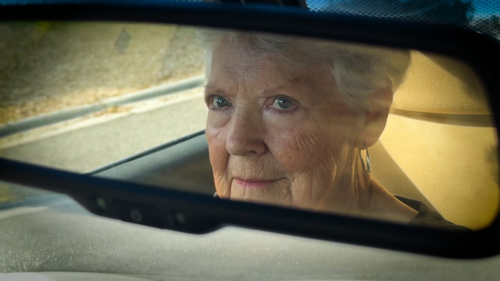June Gautier looking in her rear-view mirror.