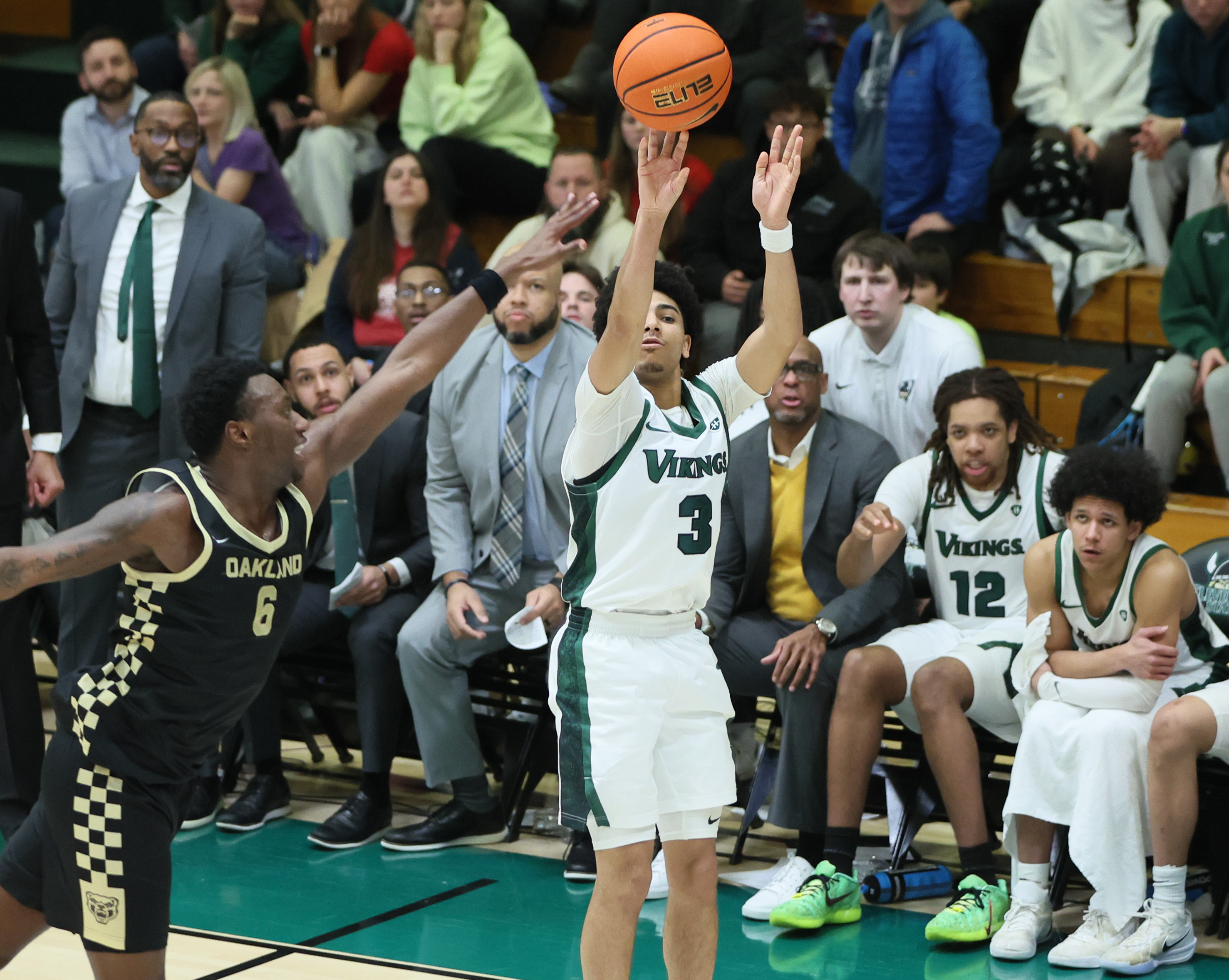 Cleveland State Vikings guard Tre Beard puts up a three-point score guarded by Oakland Golden Grizzlies forward Michael Houge in the second half.  