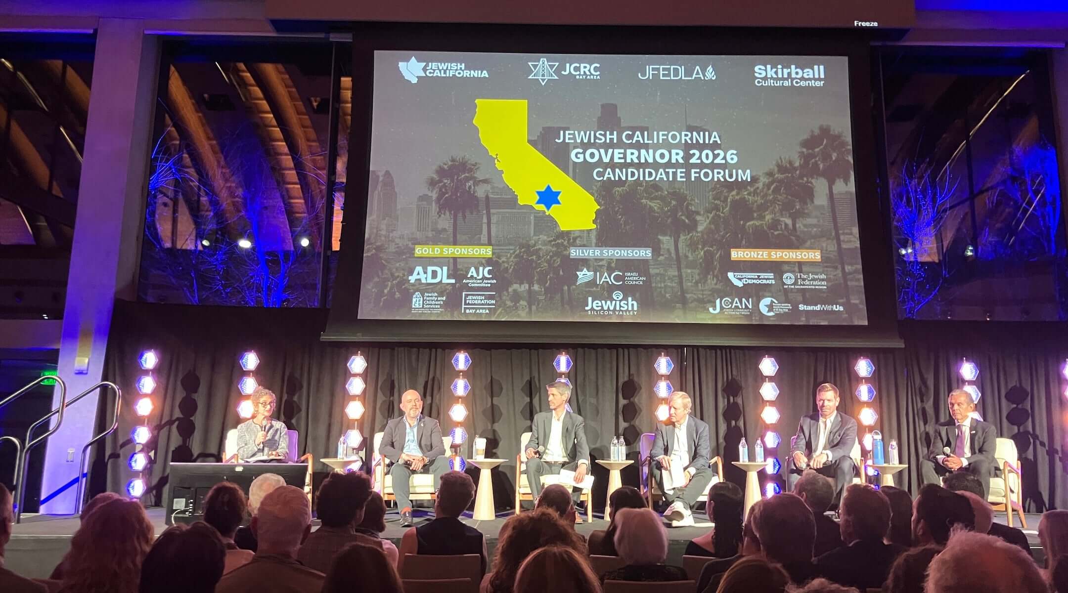 Five California gubernatorial candidates — from left, Steve Hilton, Matt Mahan, Tom Steyer, Eric Swalwell and Antonio Villaraigosa — appear on stage at the Jewish California Governor Candidate Forum at the Skirball Cultural Center in Los Angeles, where antisemitism emerged as a defining issue in the 2026 race. 