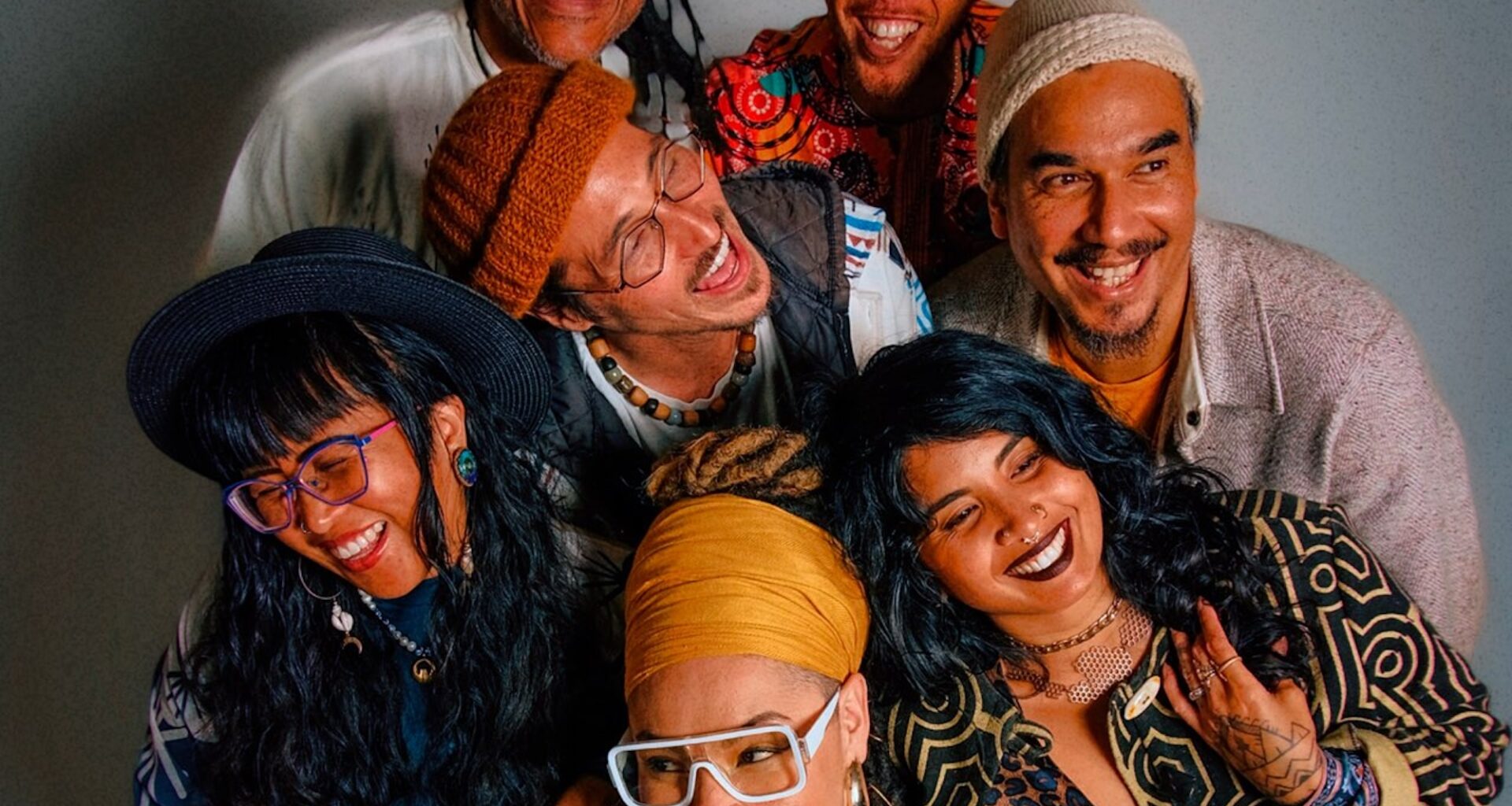 An overhead photo of seven people standing close together, almost hugging.