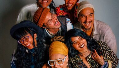 An overhead photo of seven people standing close together, almost hugging.