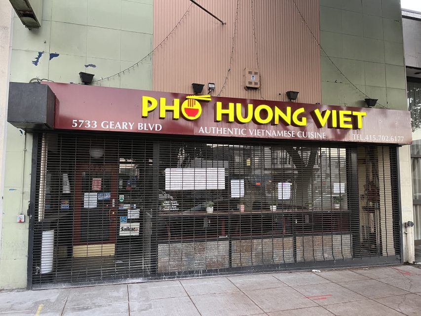 Storefront of Pho Huong Viet restaurant with metal security gate down, showing sign with address 5733 Geary Blvd and "Authentic Vietnamese Cuisine" text above the entrance.