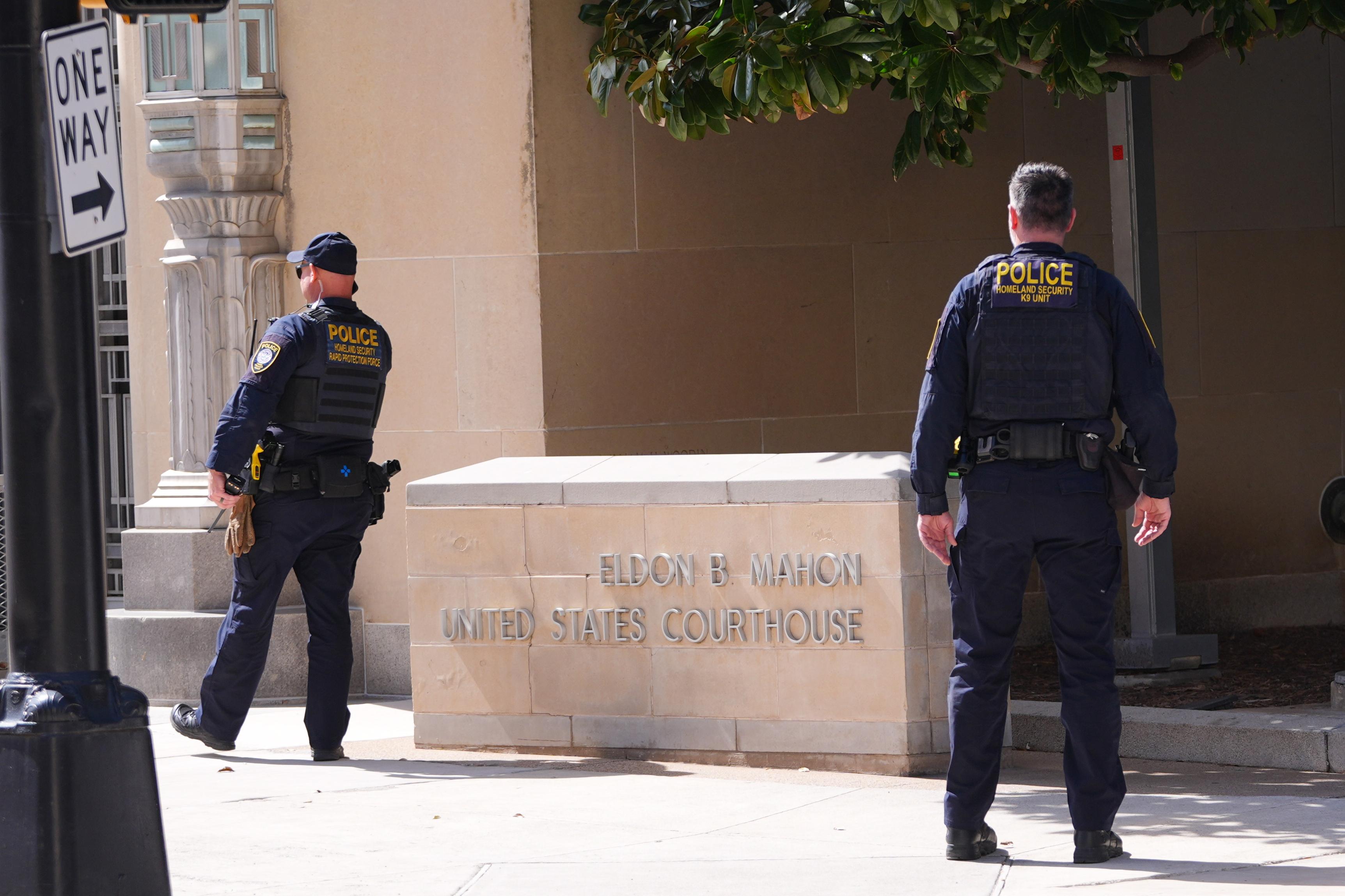 Department of Homeland Security officers stand outside the Eldon B. Mahon U.S. Courthouse.