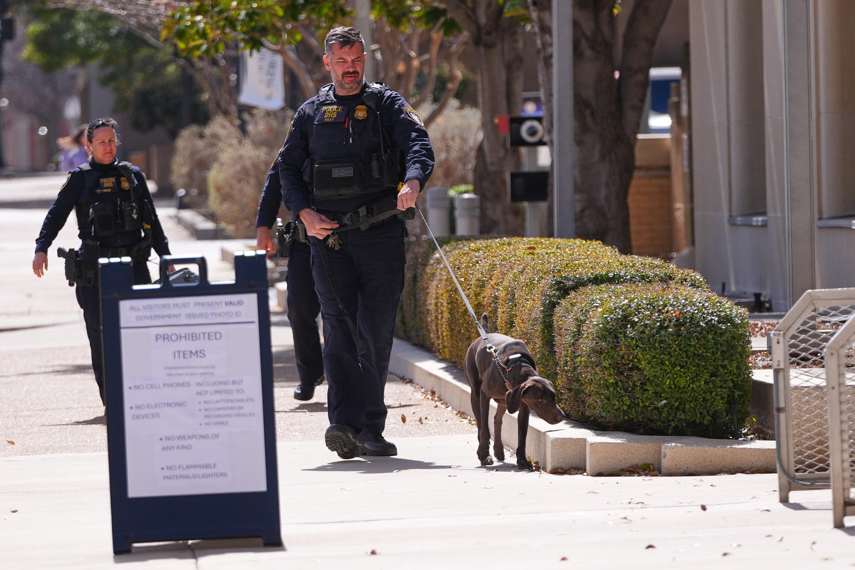 Department of Homeland Security officers patrol outside the Eldon B. Mahon U.S. Courthouse.