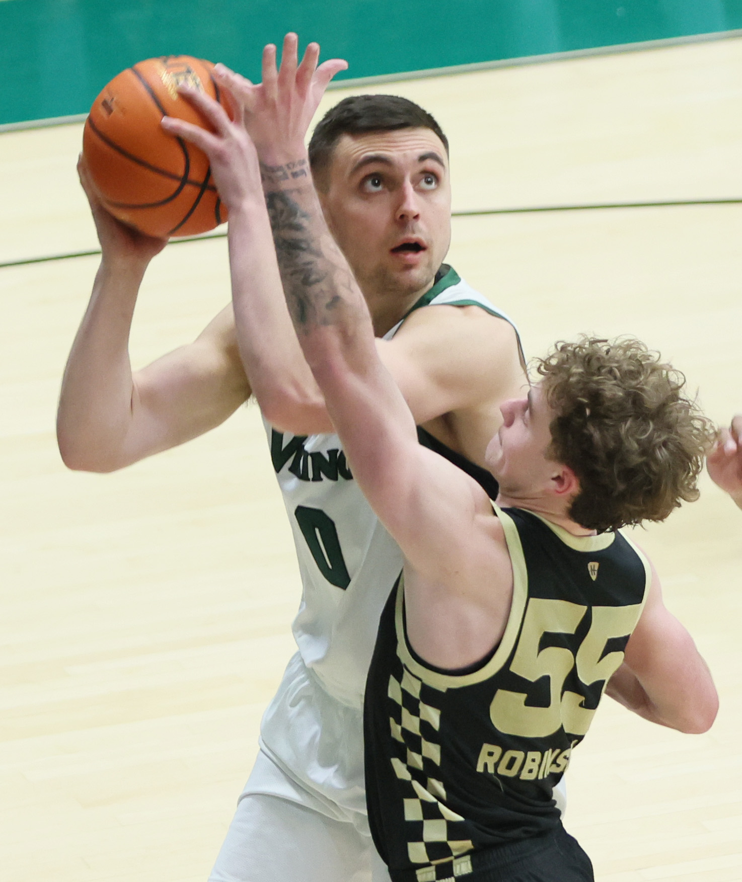 Cleveland State Vikings guard Foster Wonders eyes the basket on a shot attempt guarded by Oakland Golden Grizzlies guard Brody Robinson in the second half.  