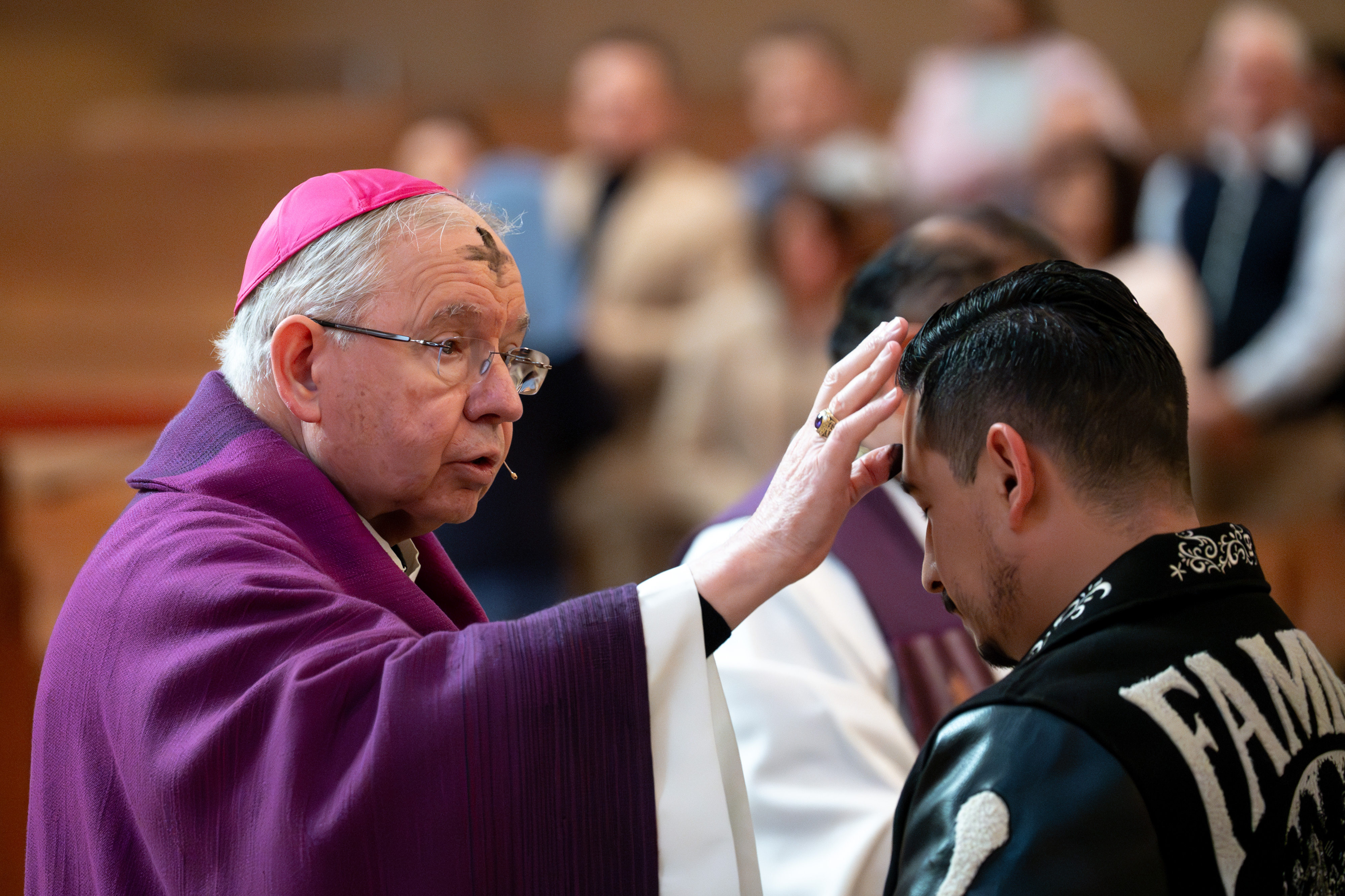 Archbishop JosÃ© Gomez marks the sign of the cross on...