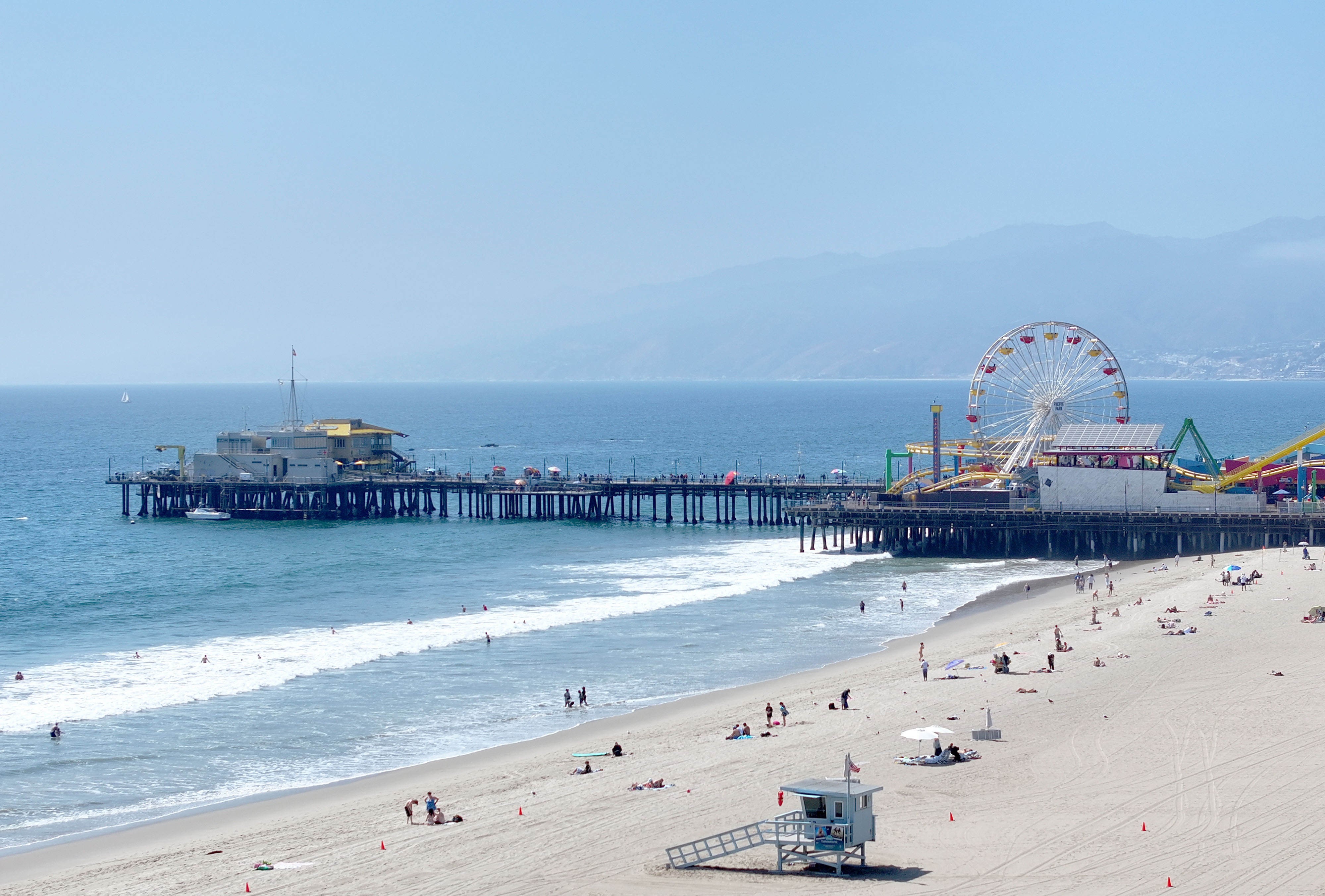 People gather south of the Santa Monica Pier on a...