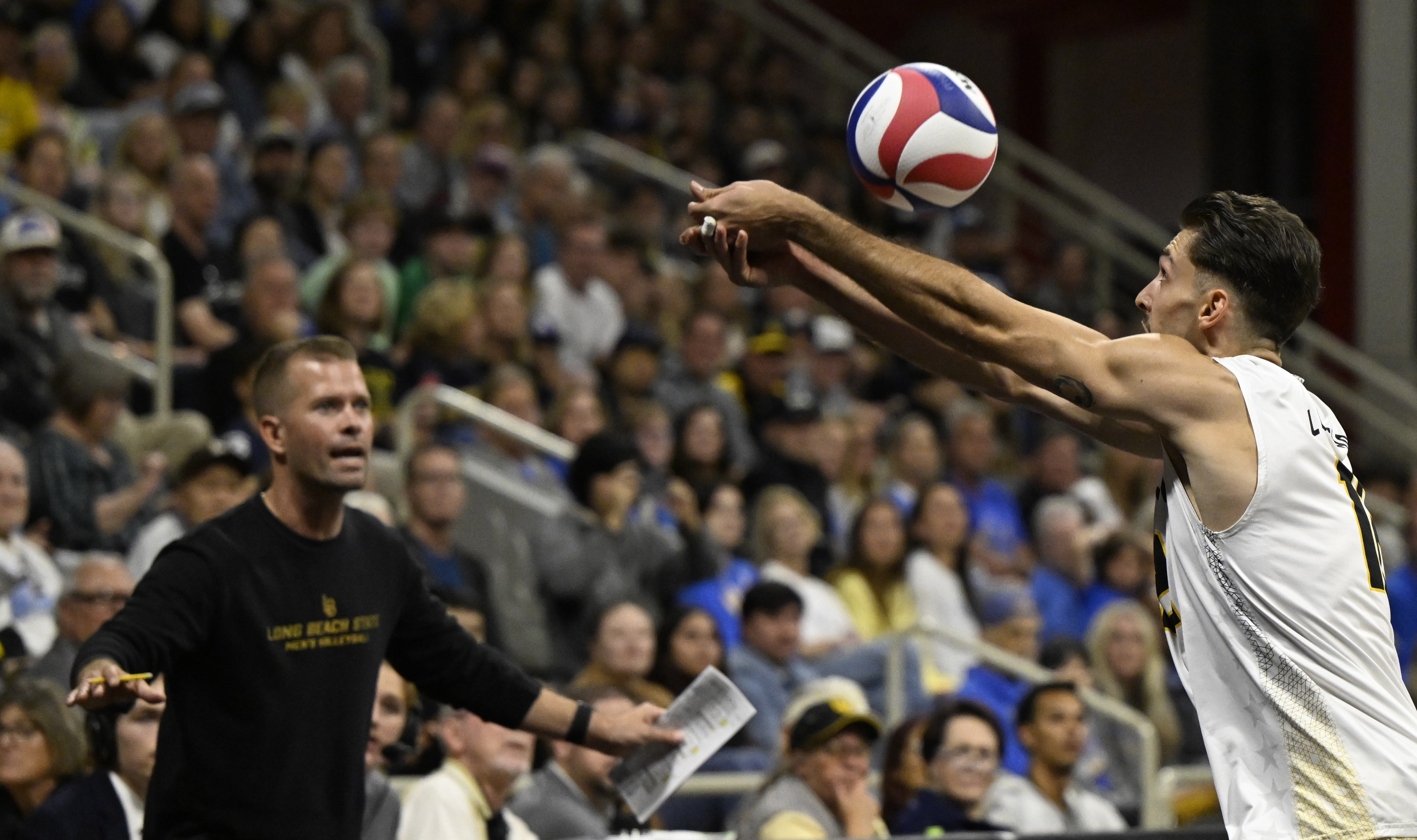 Long Beach State outside hitter Alex Kandev reaches for the...