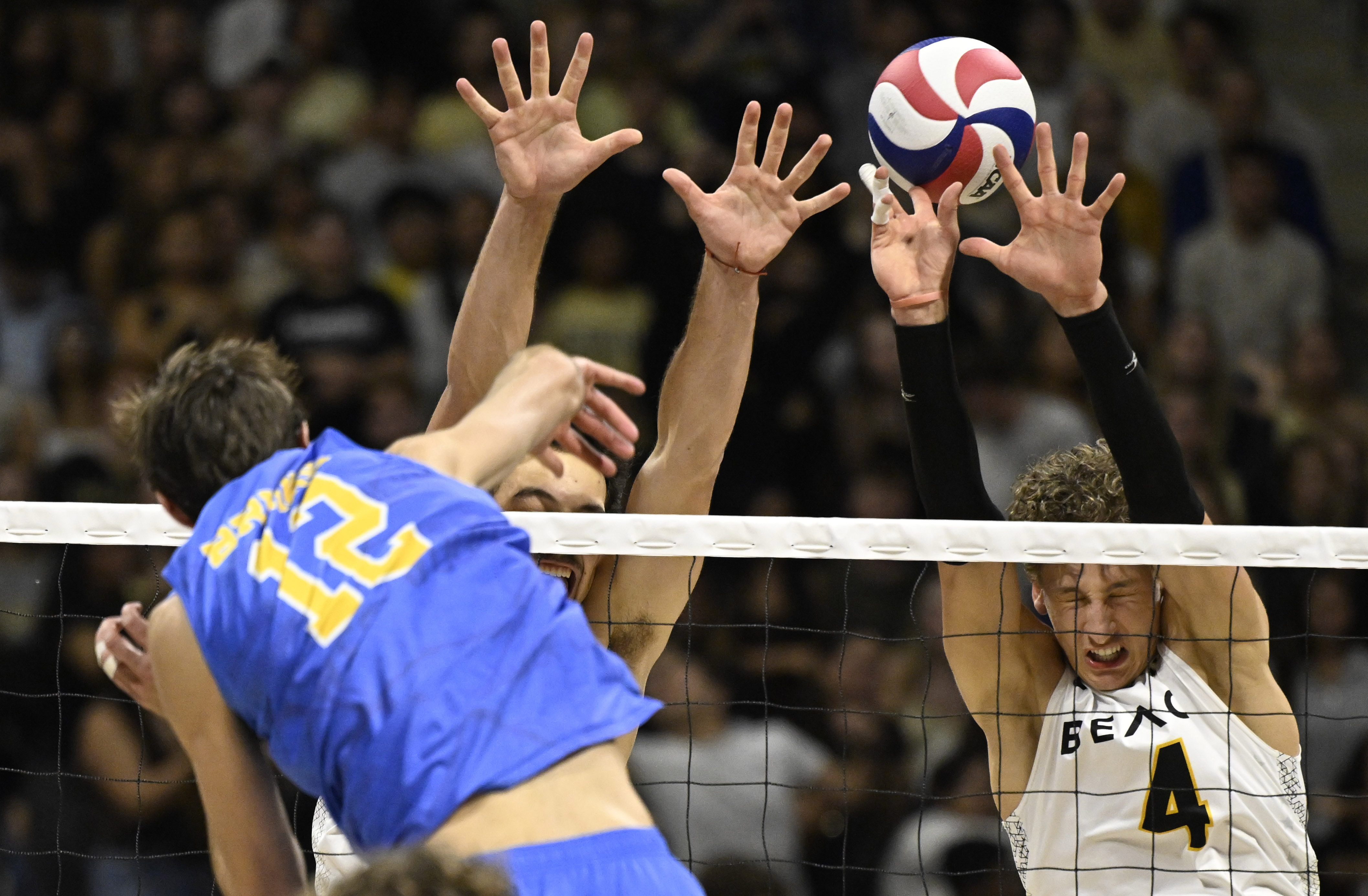 UCLA outside hitter Sean Kelly (12) sends a spike past...