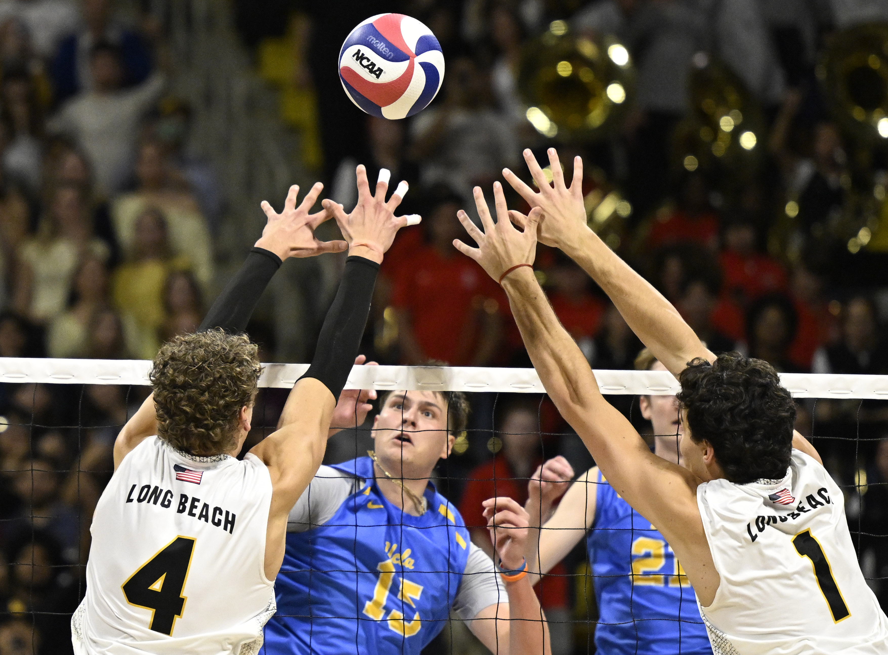 UCLA middle blocker Christopher Hersh (15) hits against Long Beach...