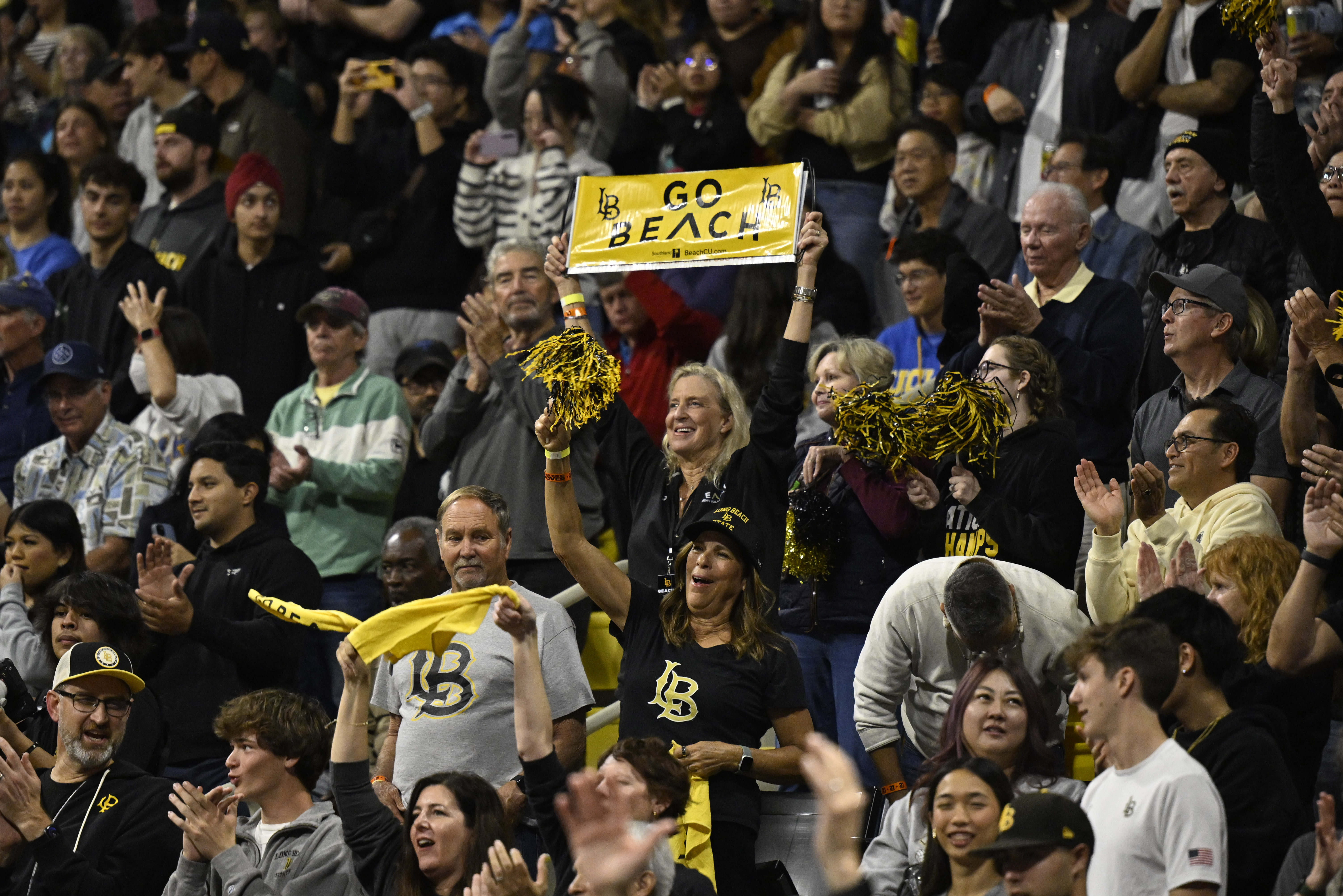 Long Beach State fans celebrate after LBSU wins the first...