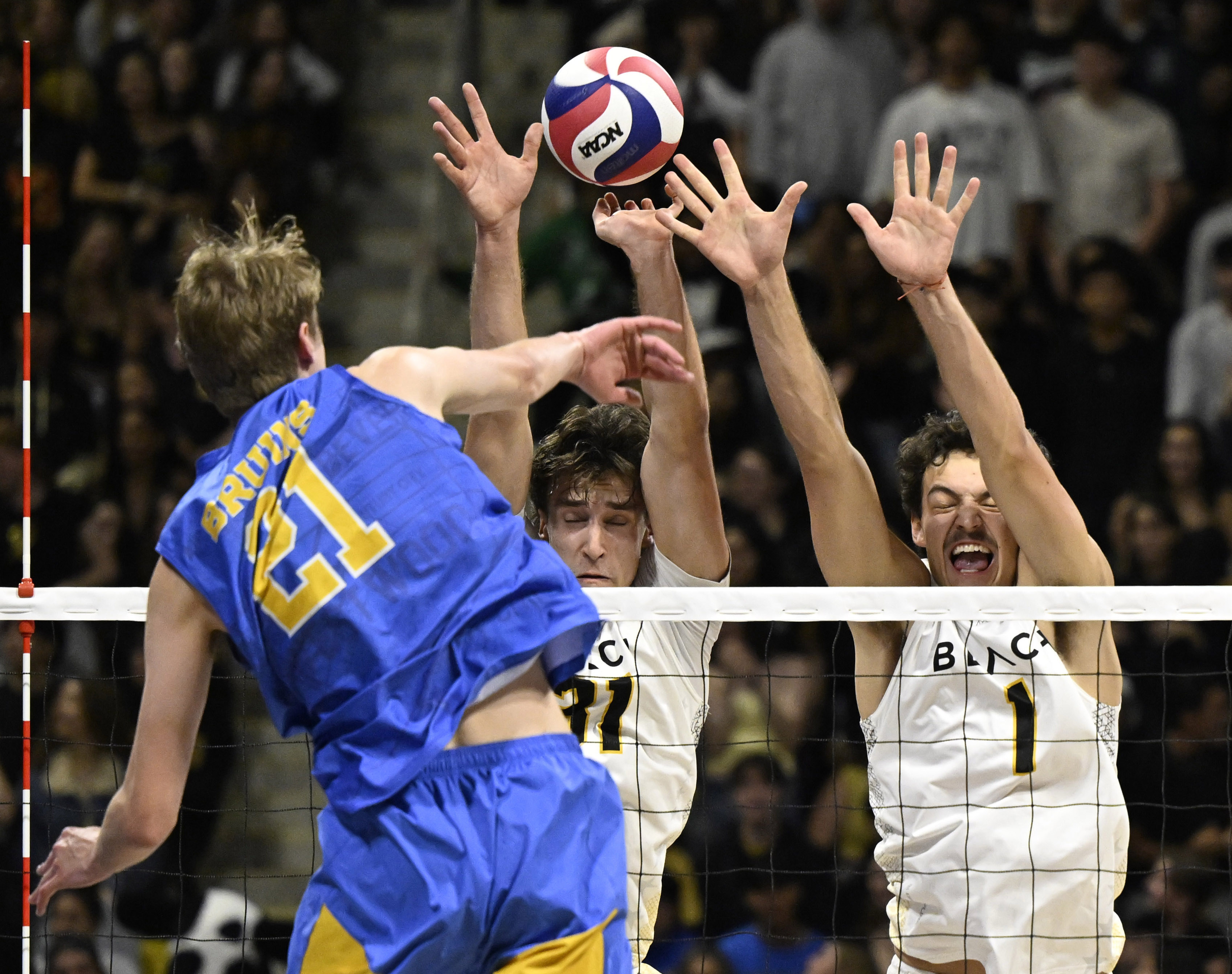 UCLA outside hitter Zach Rama (21) spikes the ball as...