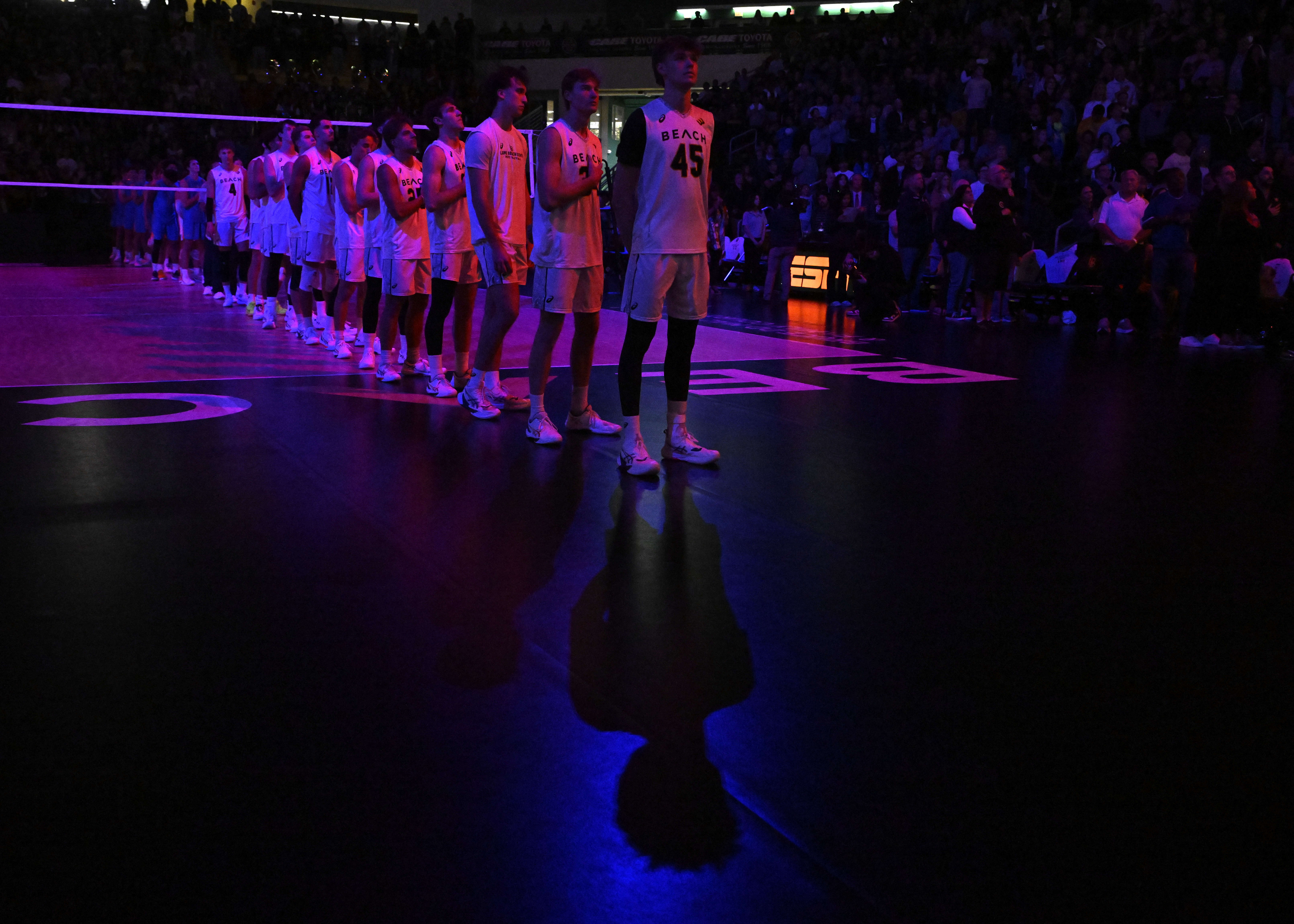 Long Beach State volleyball players stand during the National Anthem...