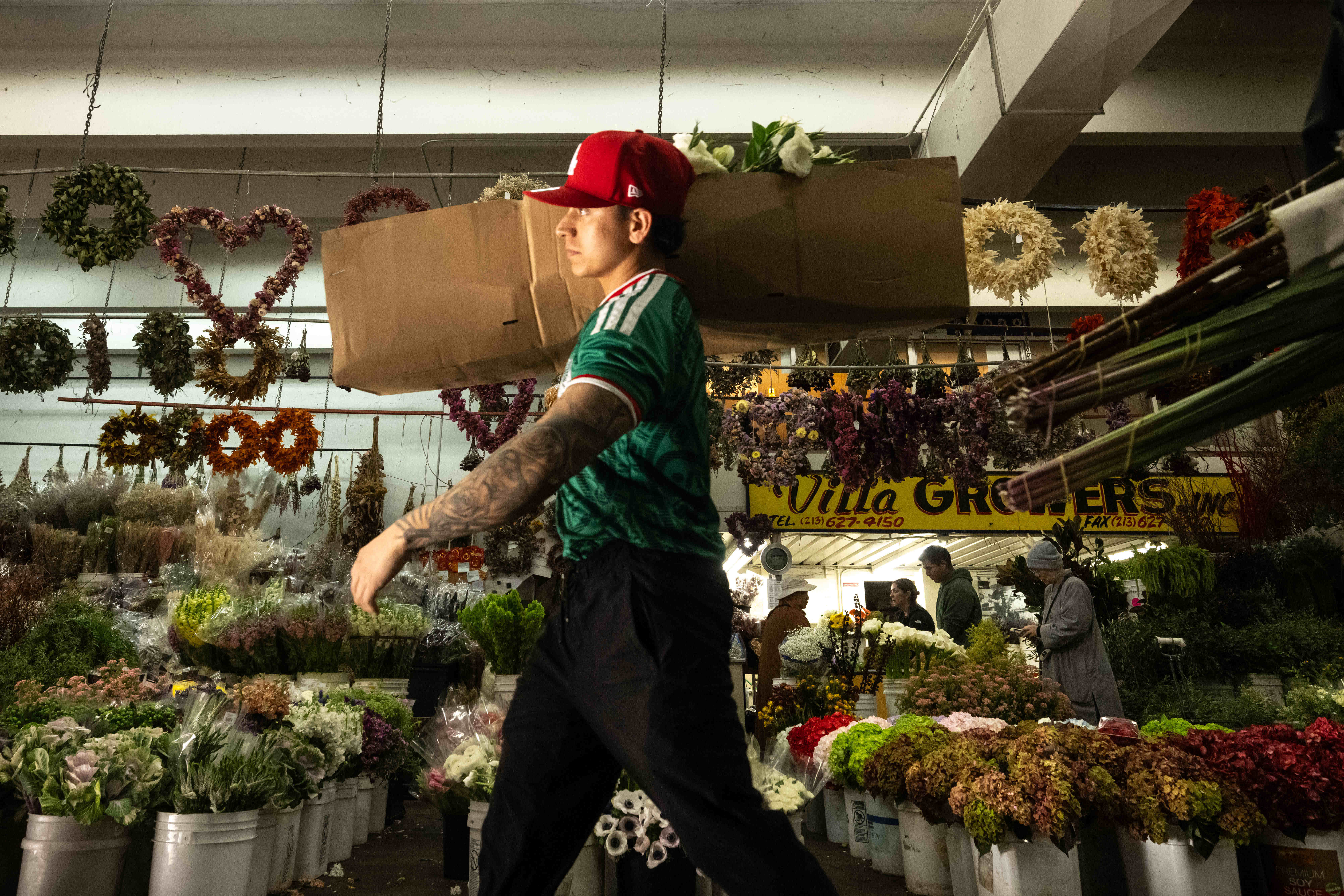 Victor, who works in the Southern California Flower Market, fills...