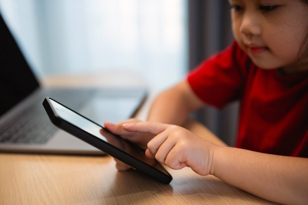 Over the past few years, her child's screen time has ranged up to 2-3 hours a day, more than double the limit recommended by pediatricians. (Woraphon Nusen/Dreamstime/TNS)