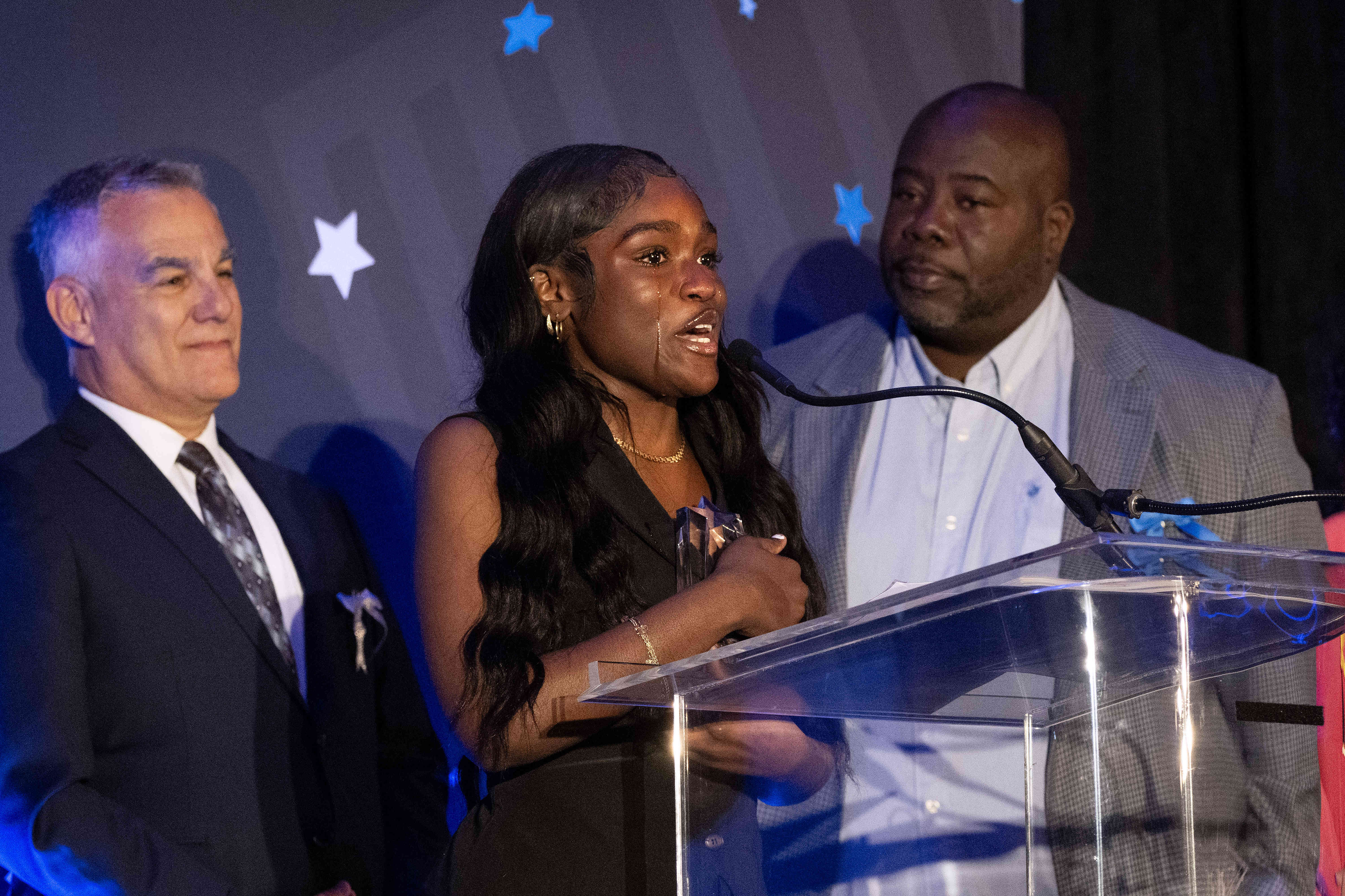 Samajahe King, center, speaks after receiving the Youth of Year...