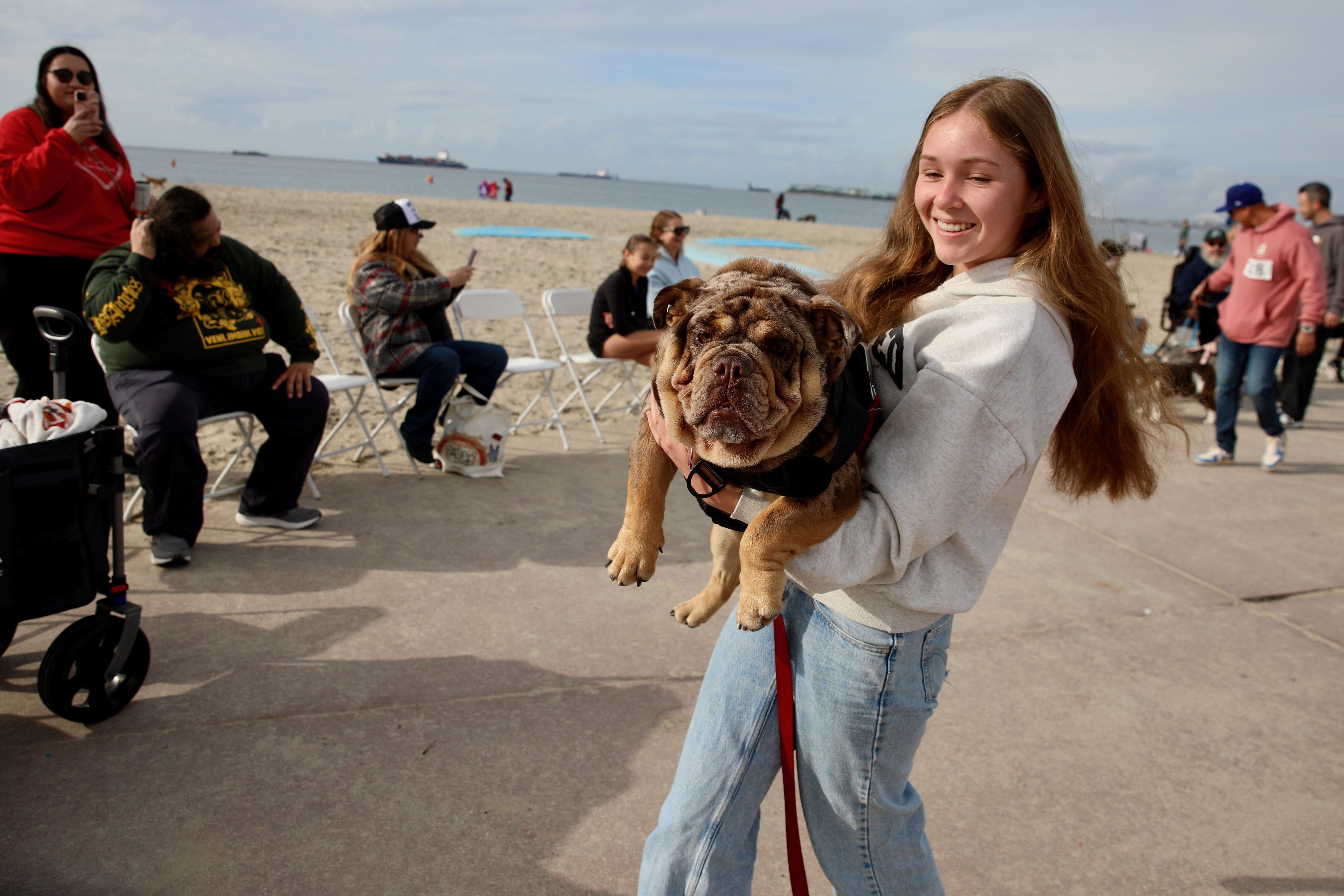 Caragh Amaya of Chino Hills carries 7-month-old Rico as participants...