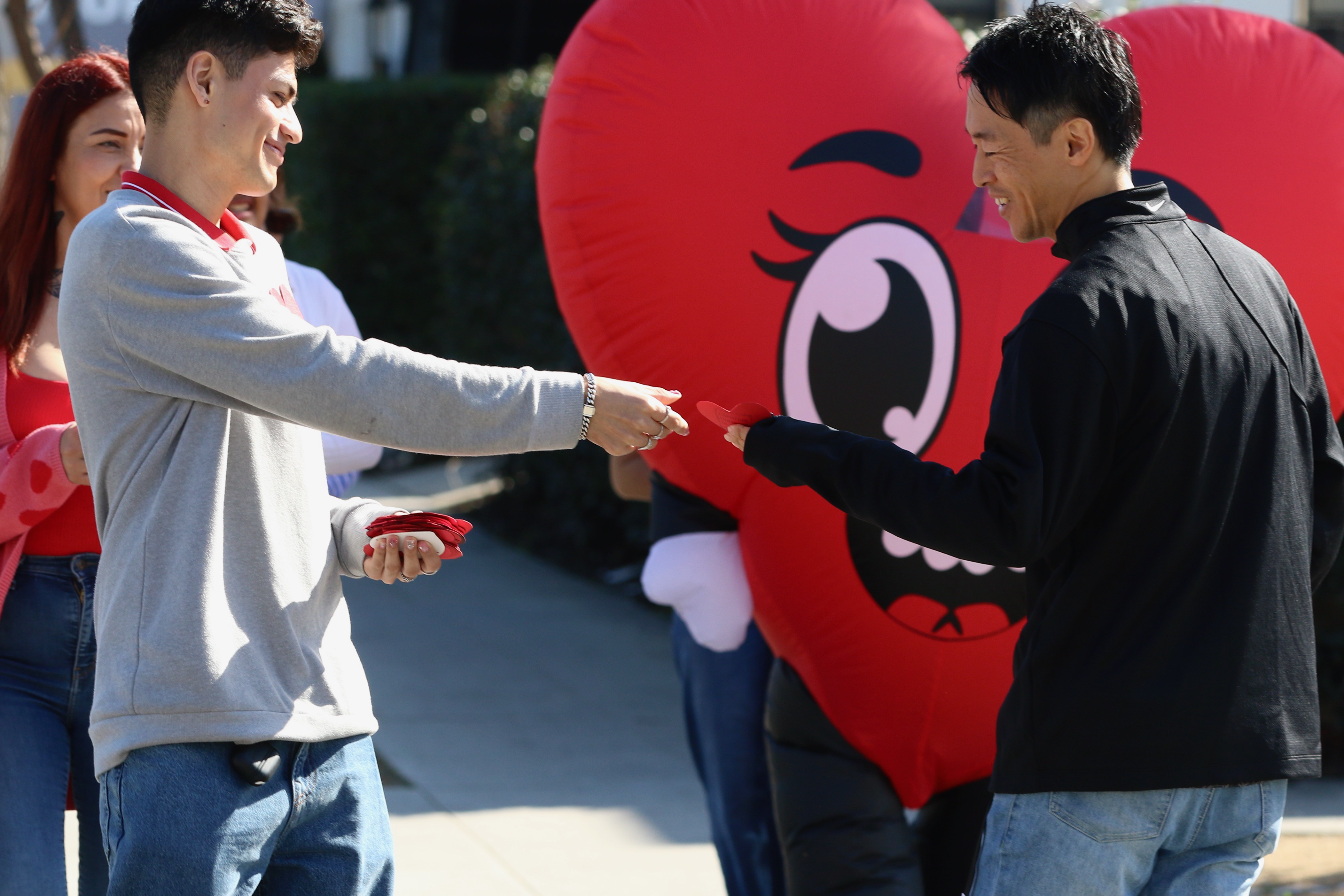 Volunteers from Christian Outreach in Action walk through downtown Long...