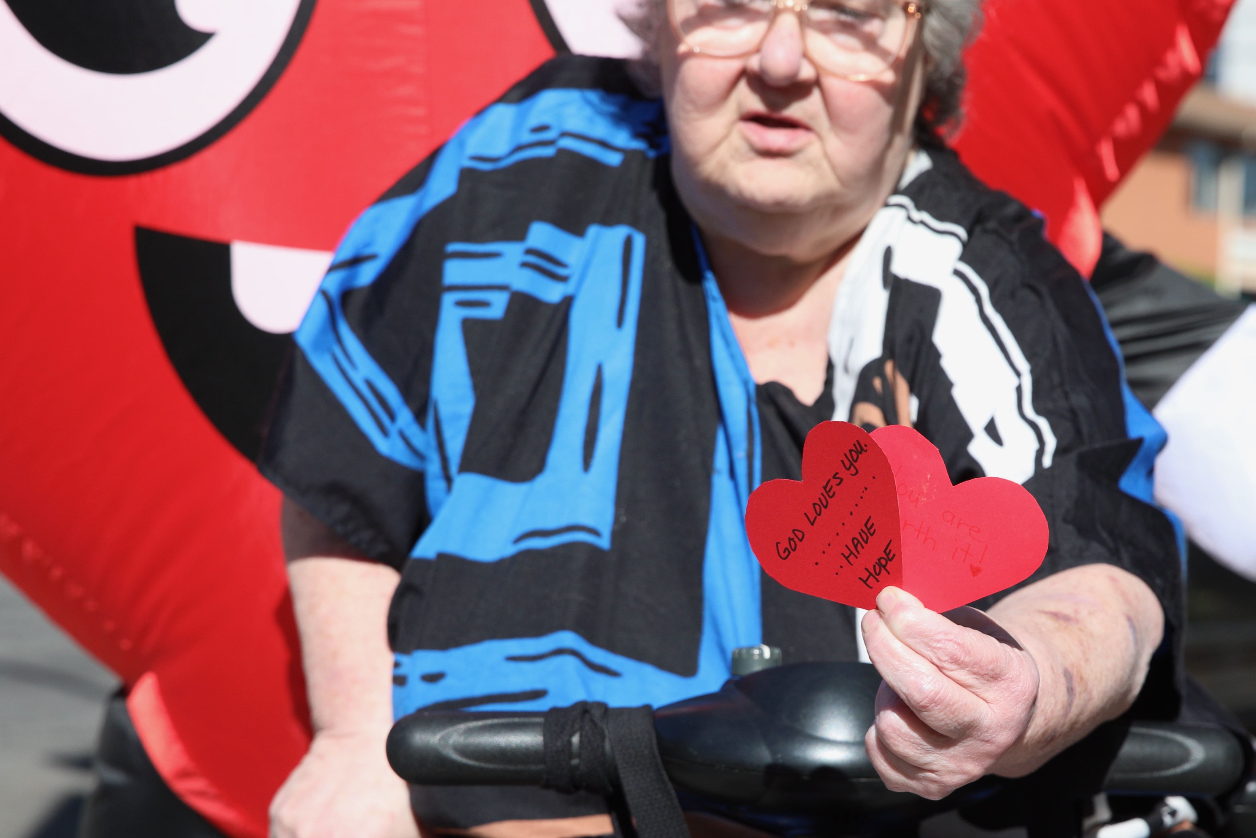 Cathlene Caccavalla displays a paper heart with the hand-written message...