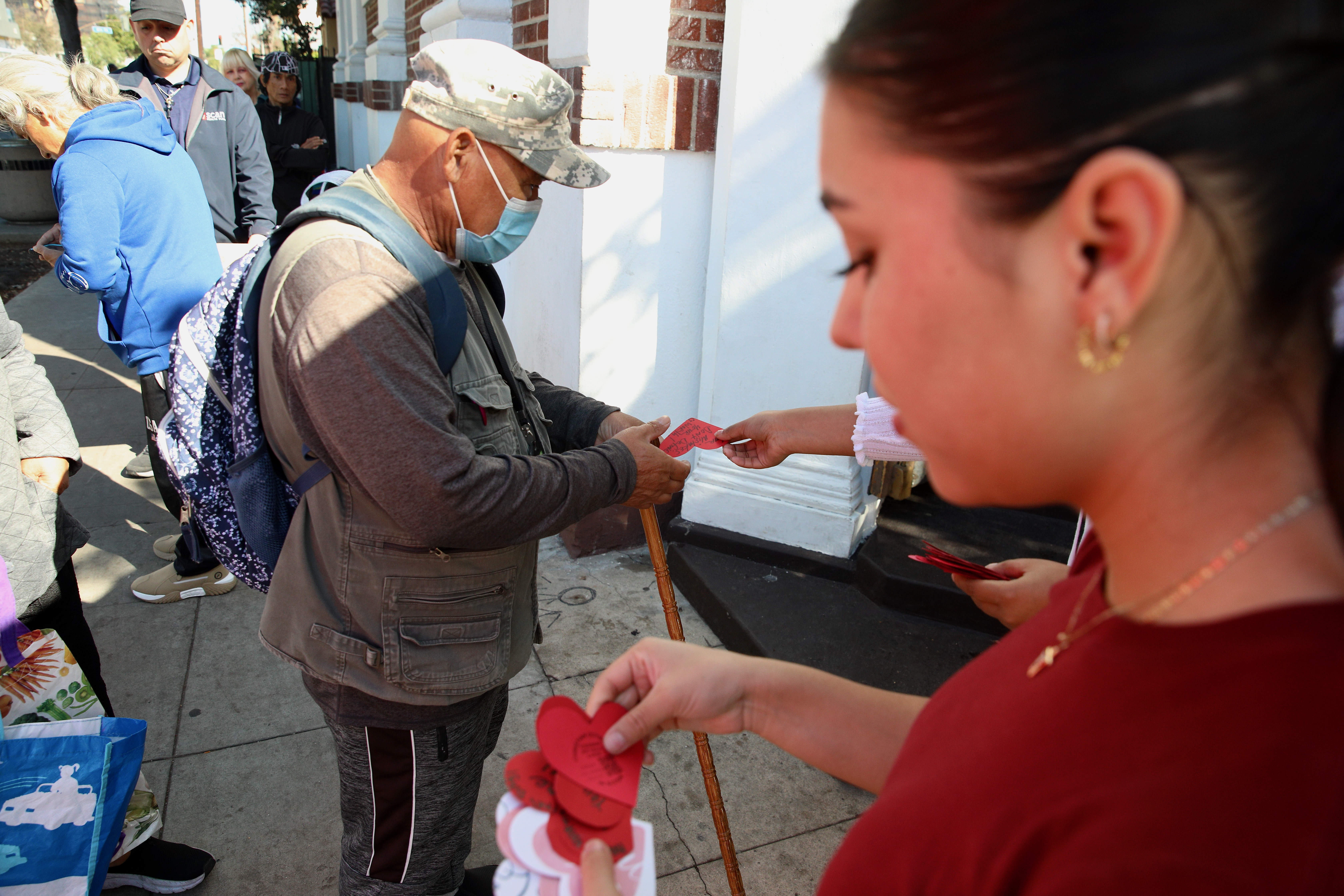Volunteers from Christian Outreach in Action in Long Beach hand...