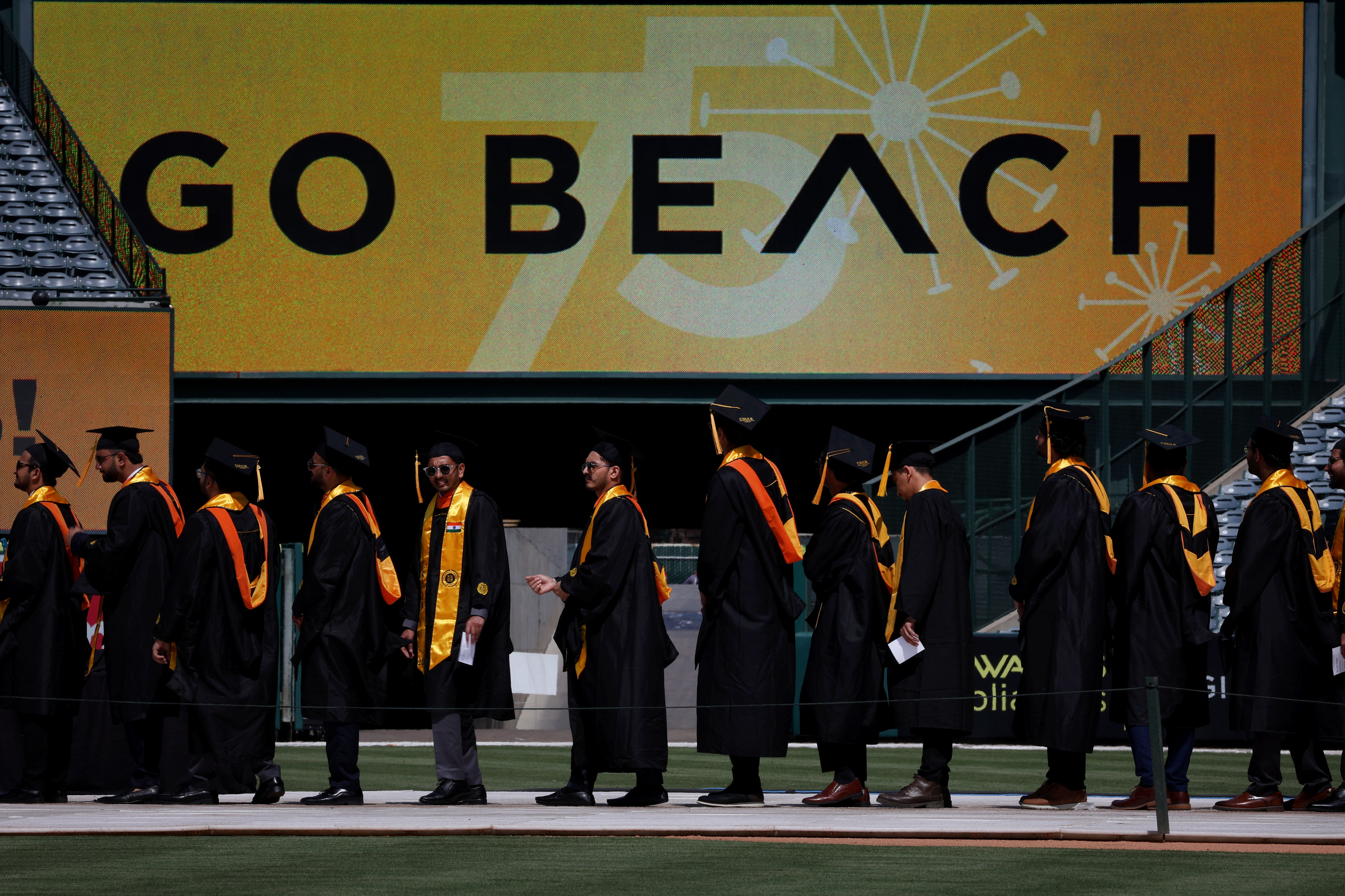 Cal State Long Beach College of Engineering graduates wait in...