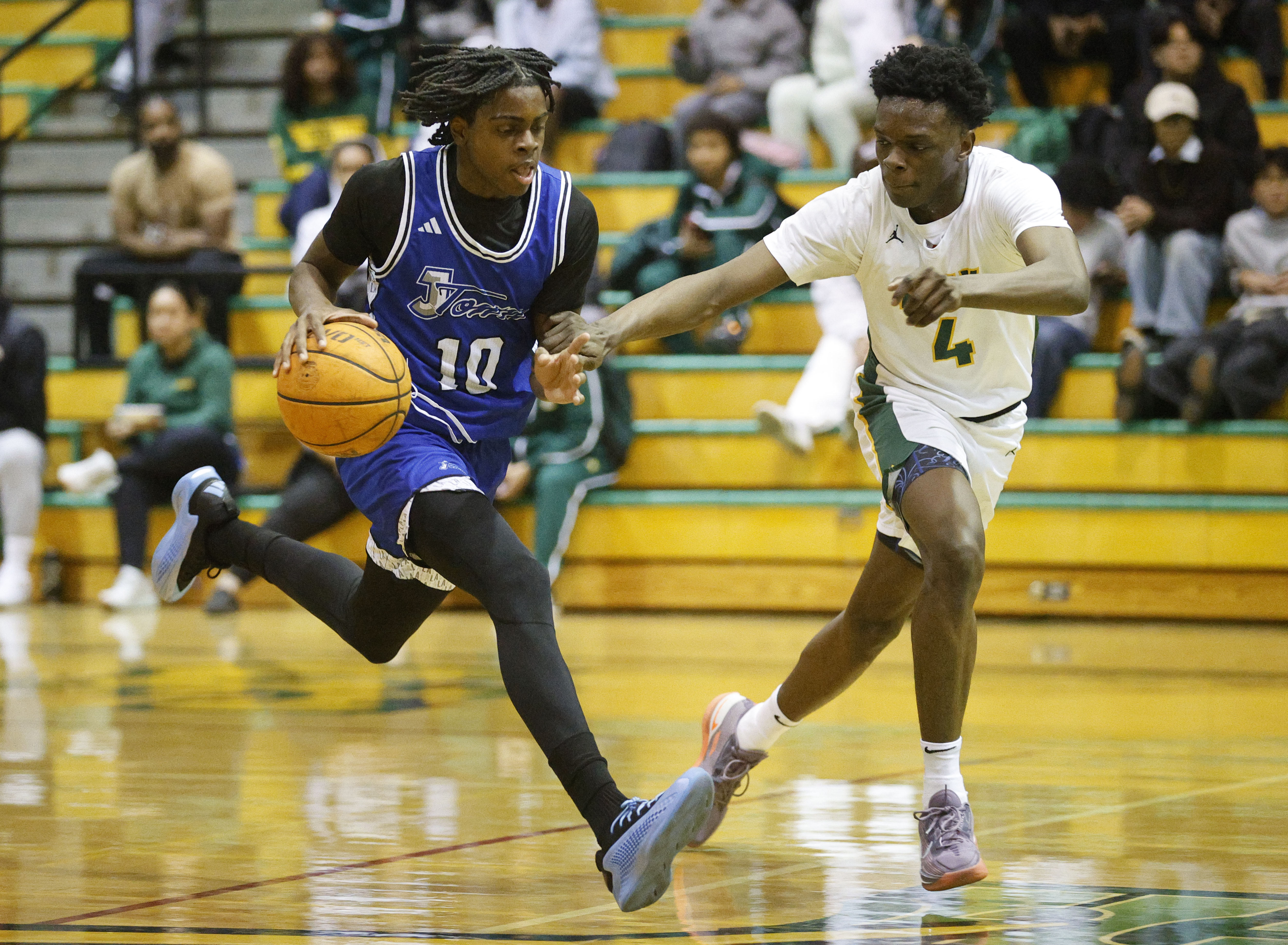 Jordan’s Aaron Chiles looks to get past Long Beach Poly’s...