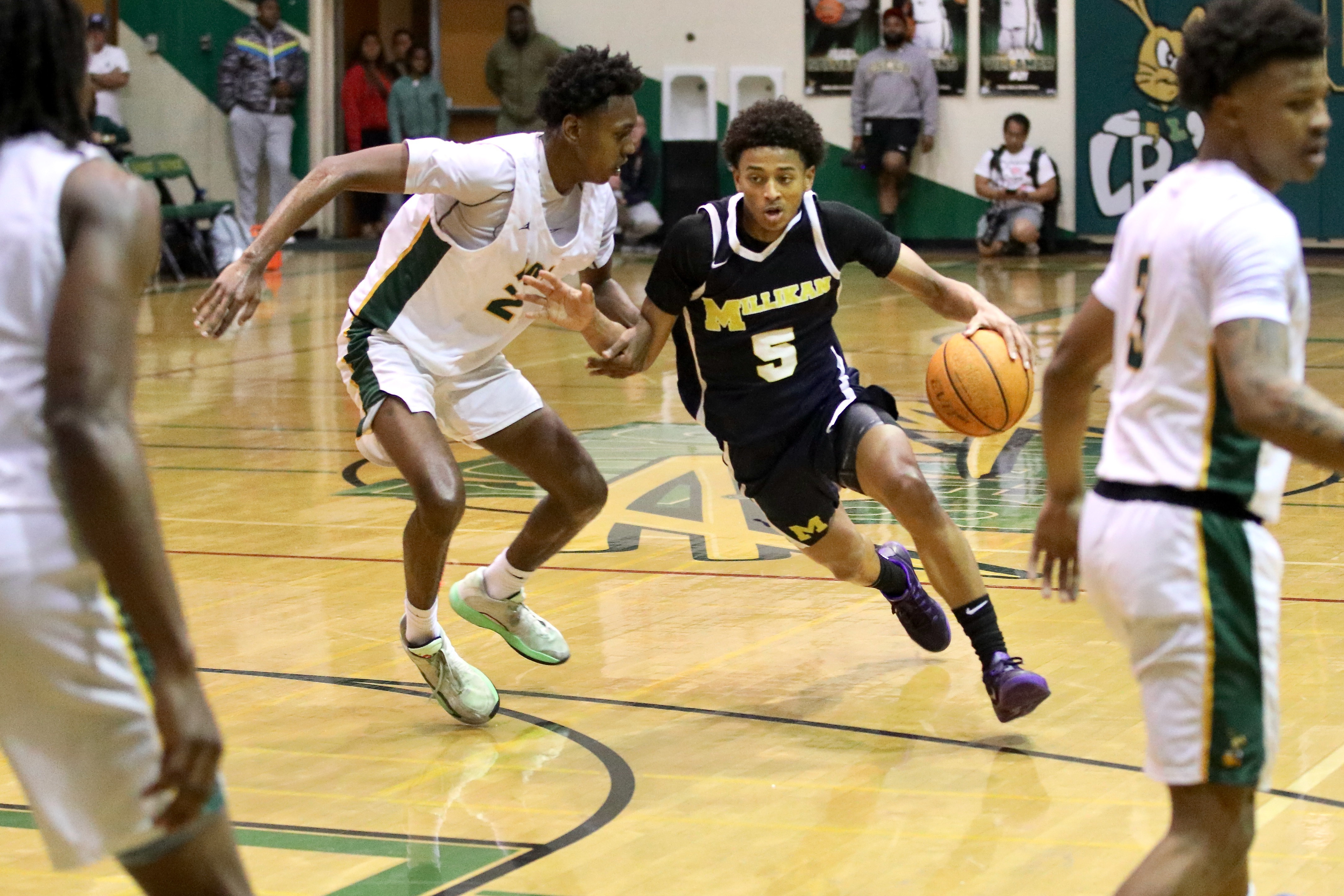 Millikan’s Quali Giran drives on Long Beach Polyâs Nana Ofoegbu...