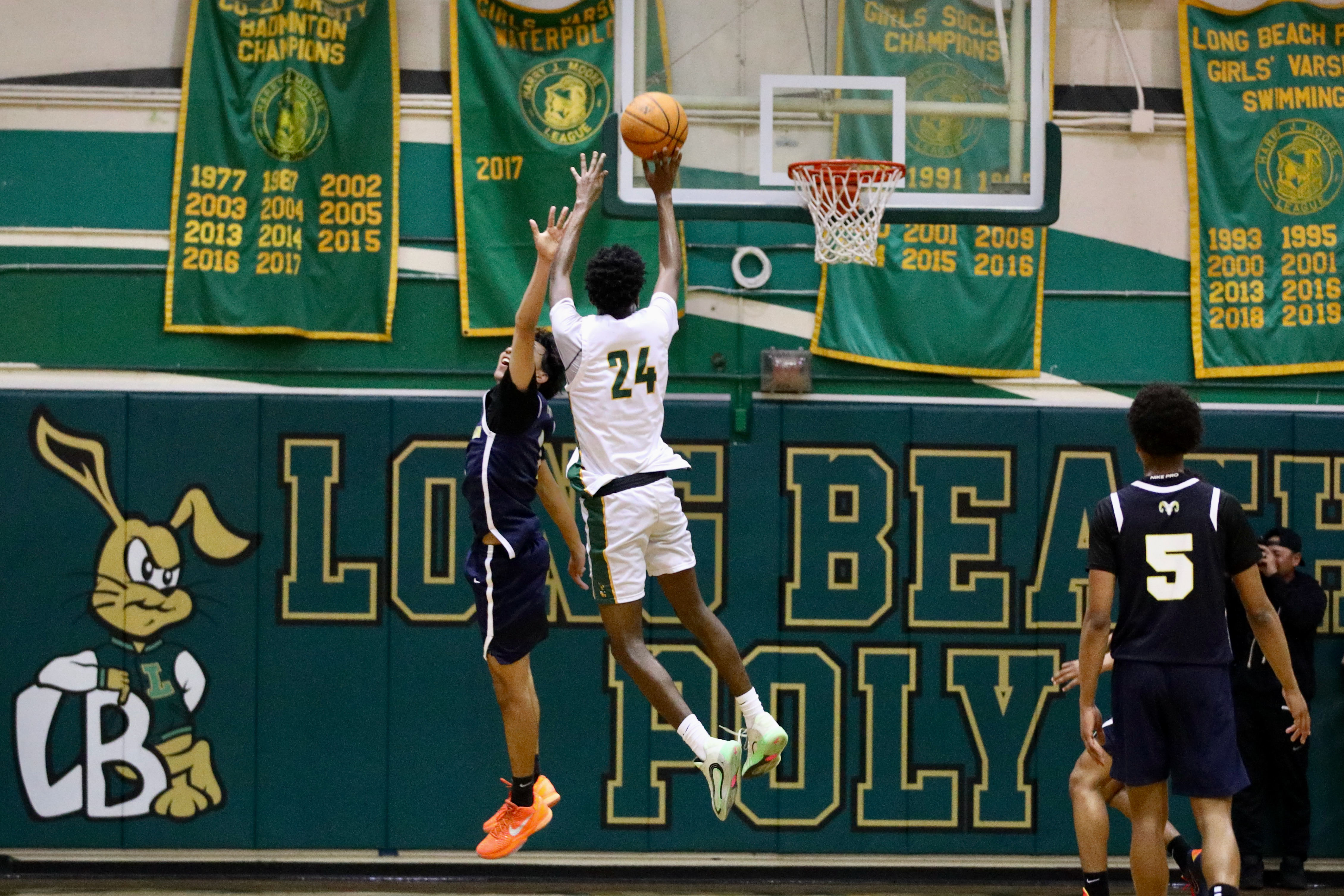 Long Beach Poly sophomore guard Jayden Ganther connects for two...