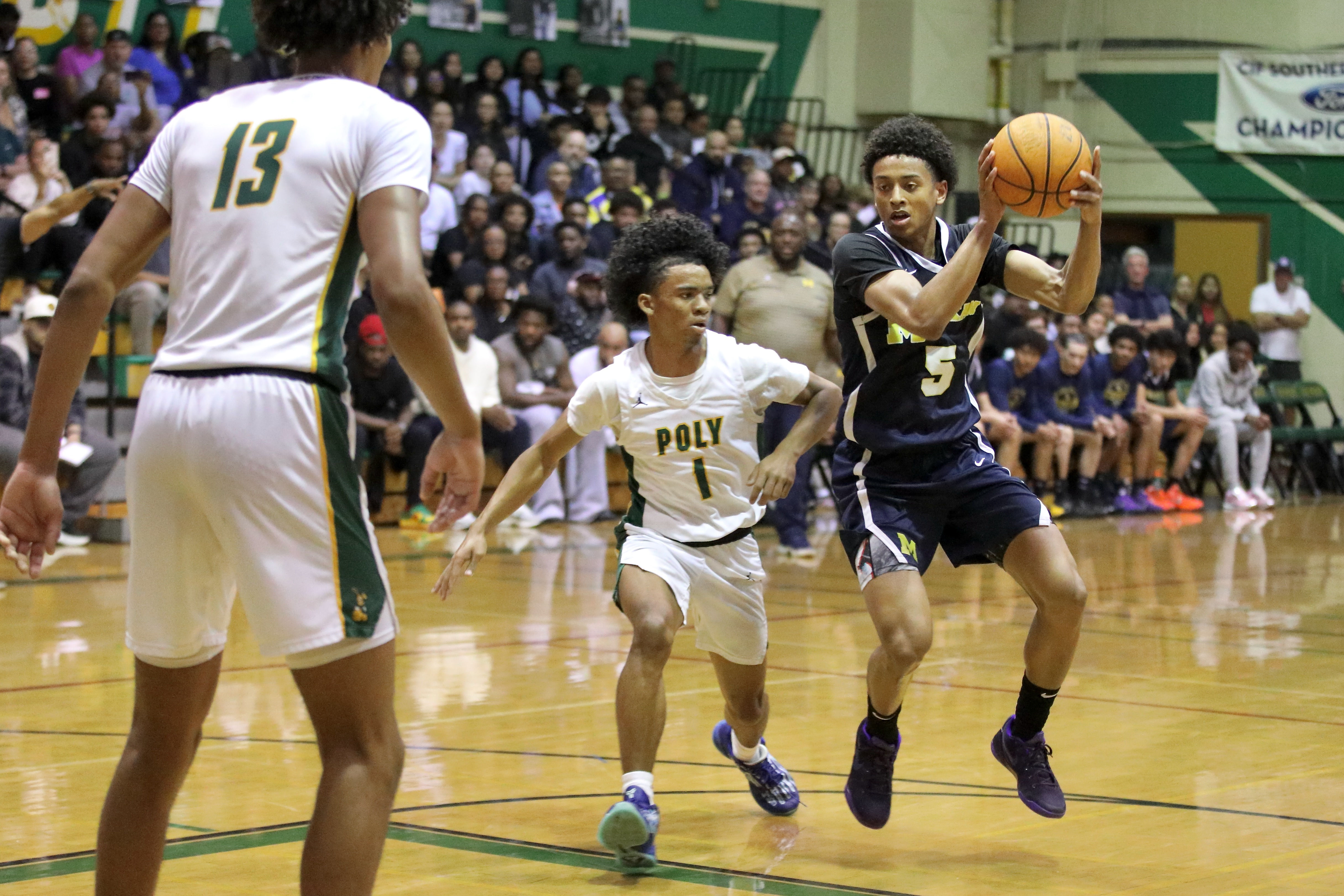 Millikan’s Quali Giran maneuvers around Long Beach Polyâs Khalen Shepard...