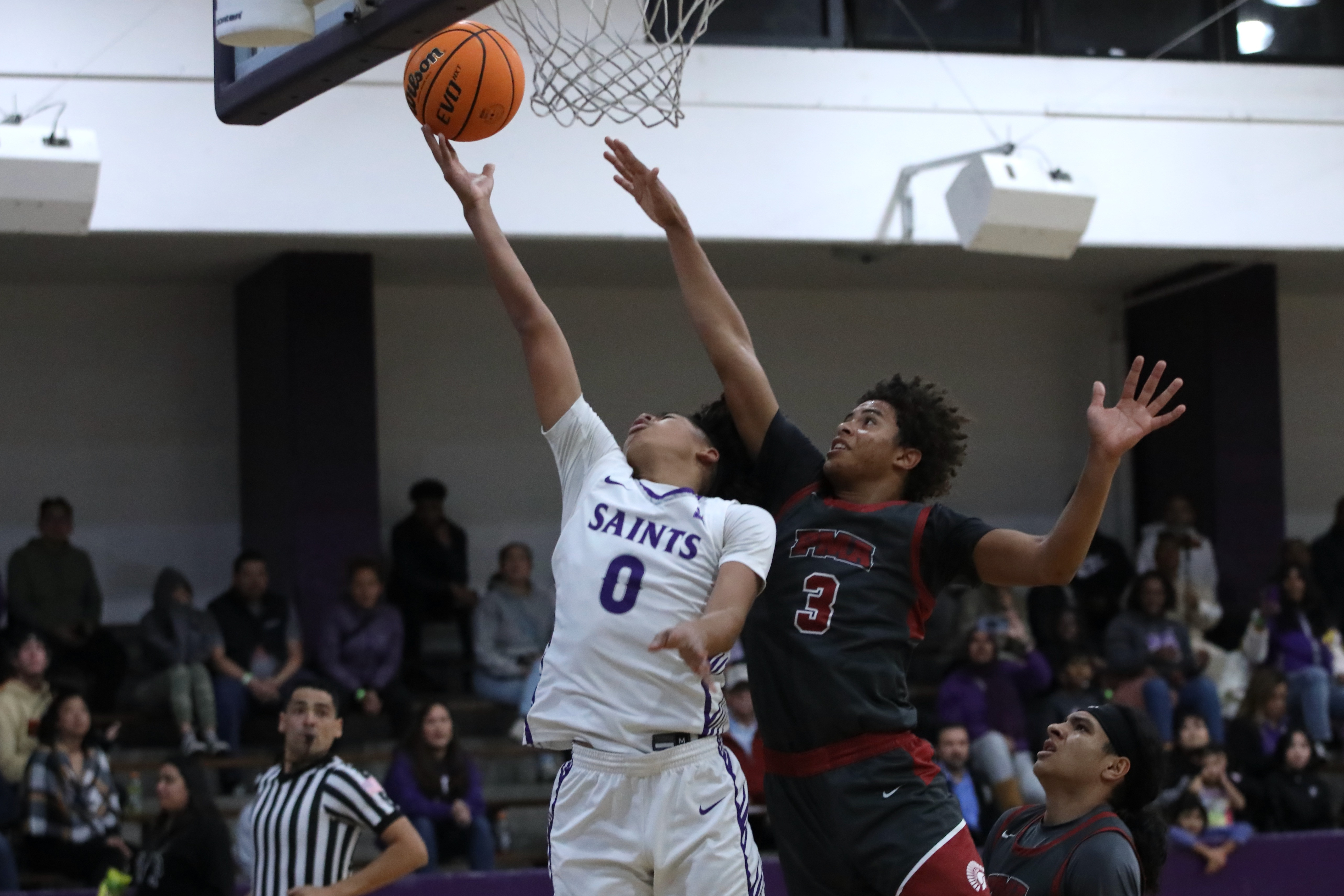 St. Anthony sophomore guard JoJo Wicker scores ahead of St....