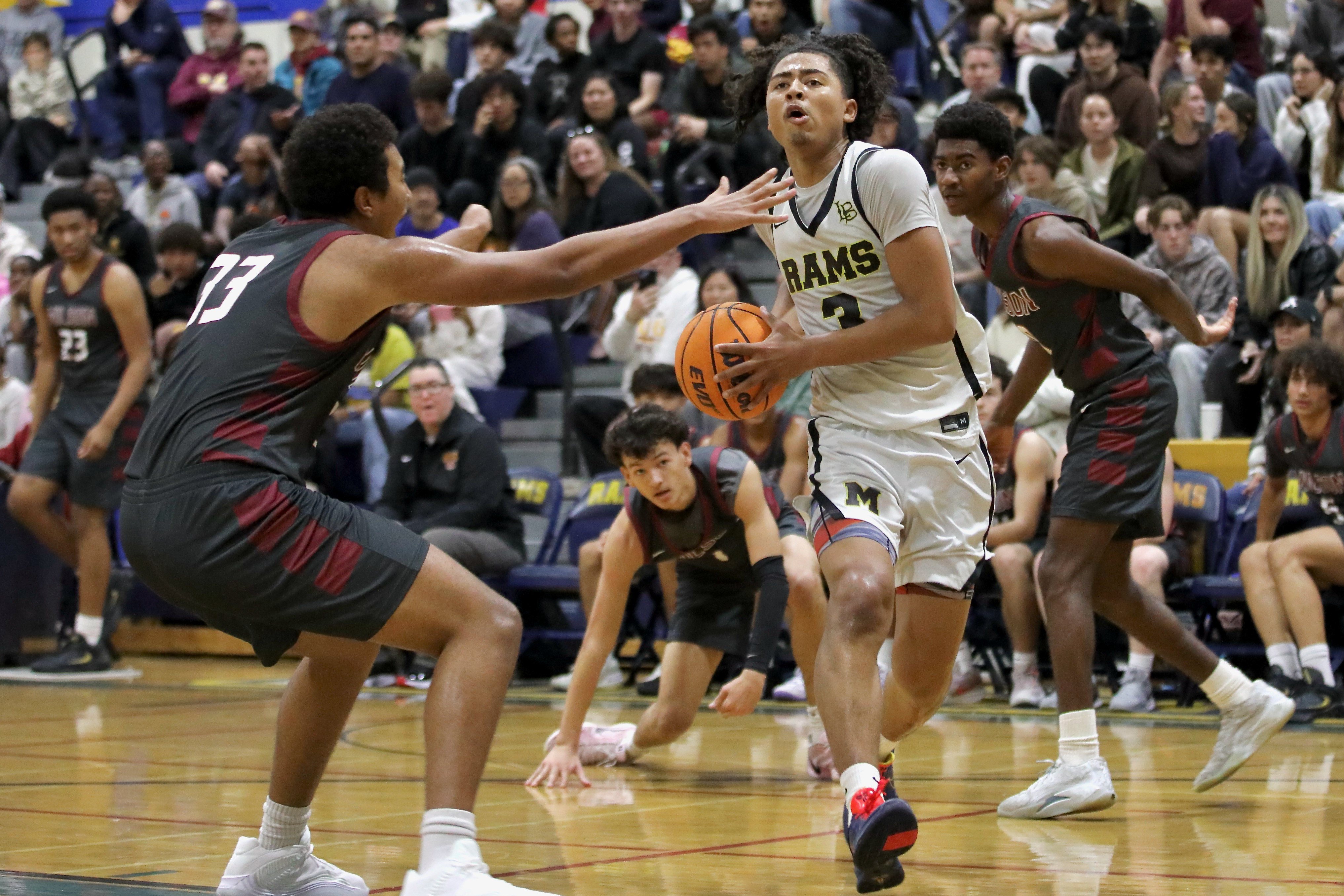 Millikan senior guard Joseph Wicker drives to the hoop on...