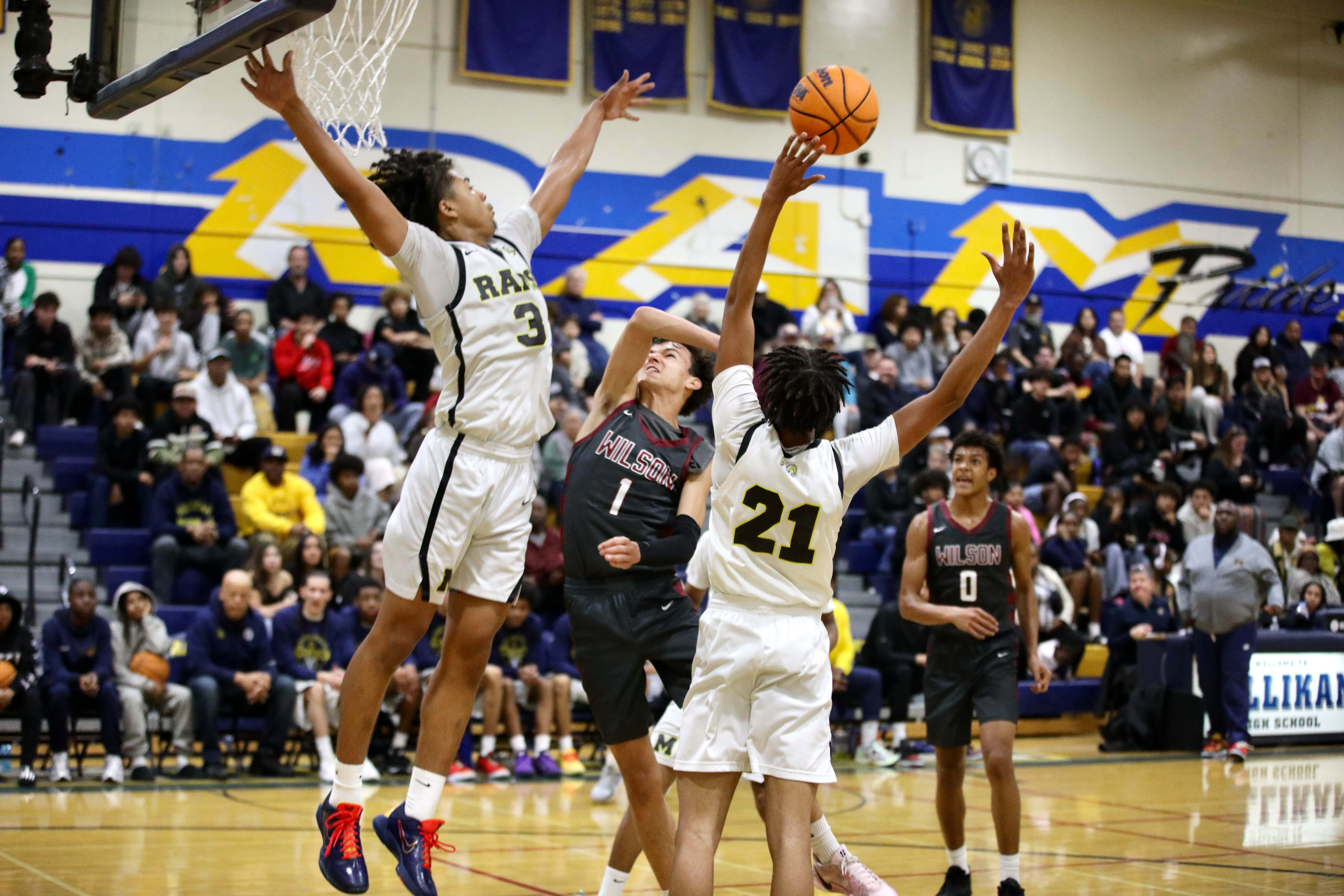 Millikanâs Joseph Wicker (3) and Christian Parron (21) defend against...