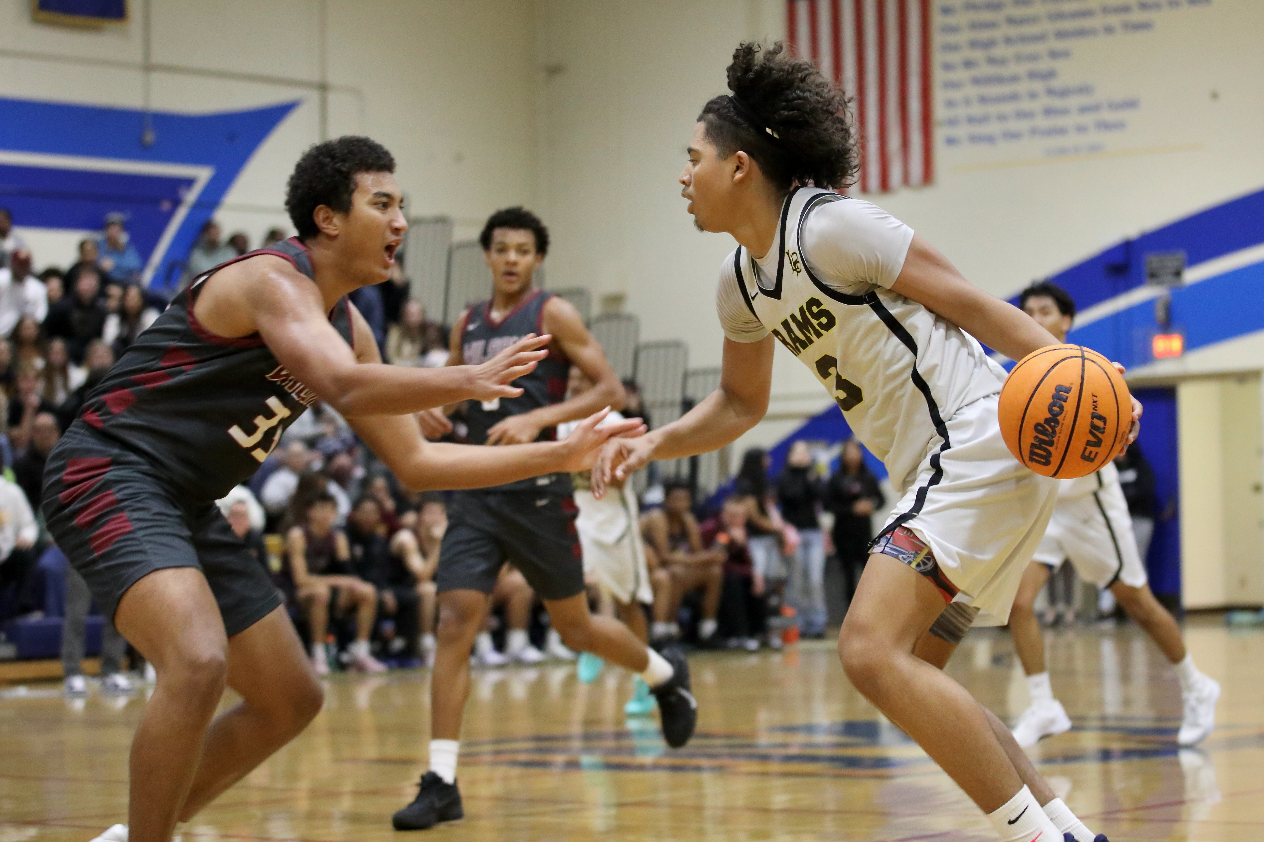 Millikanâs JoJo Wicker drives on Wilsonâs Enzo Haramis in Moore...