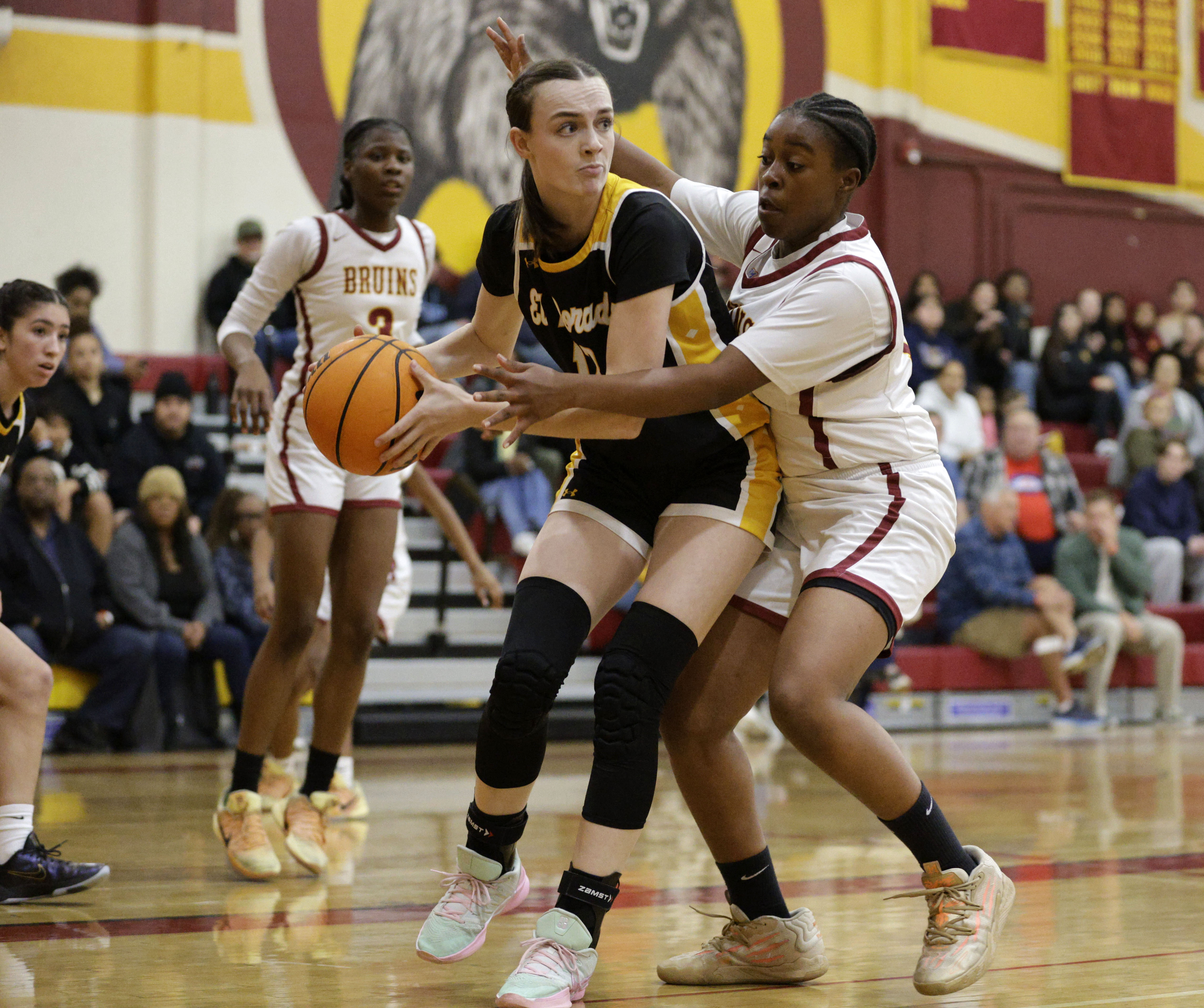 Wilson’s Tyshana Alexander (14) puts the pressure on El Dorado’s...