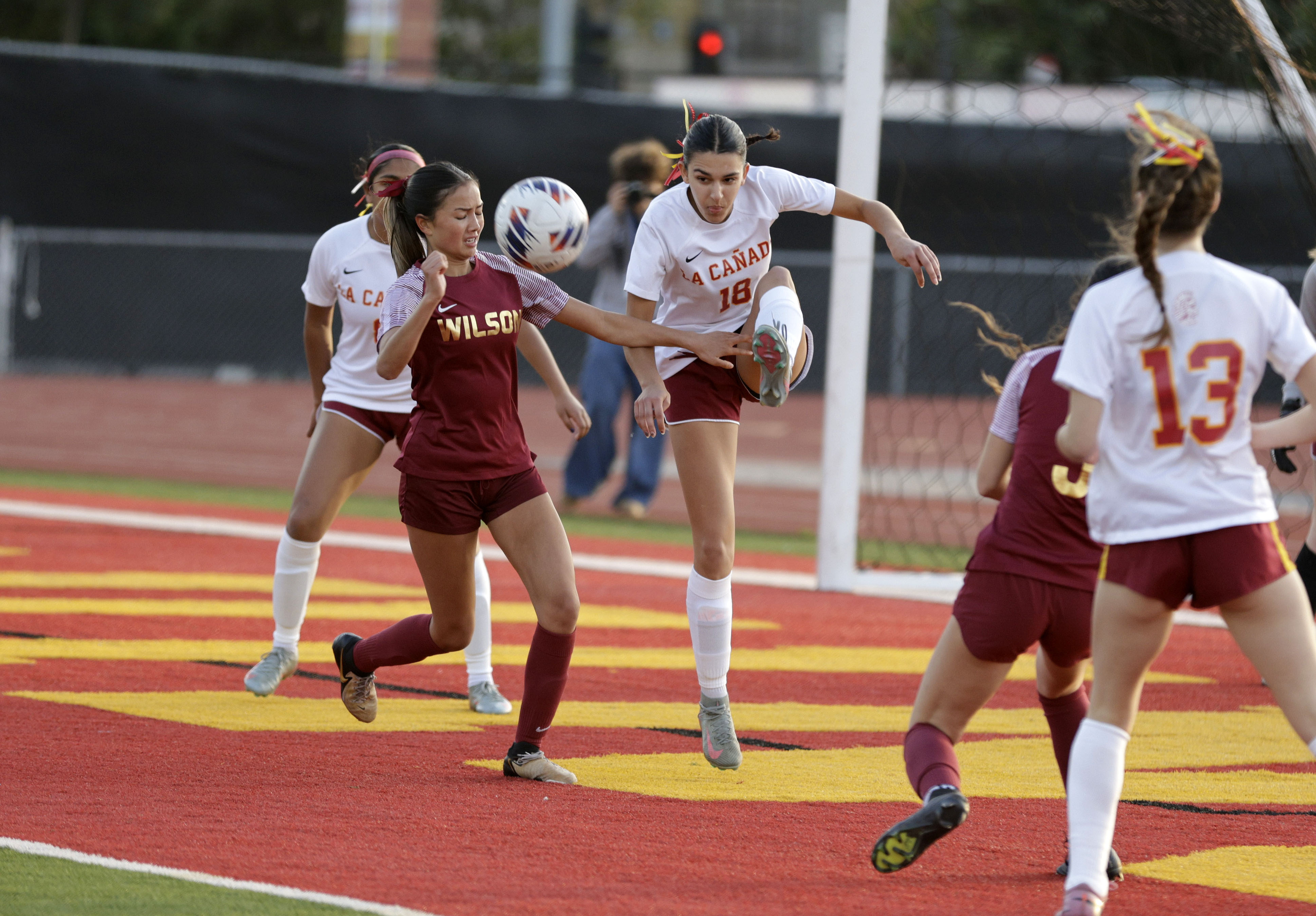 La Canada’s Alyssa Dayha (18) kicks the ball away from...