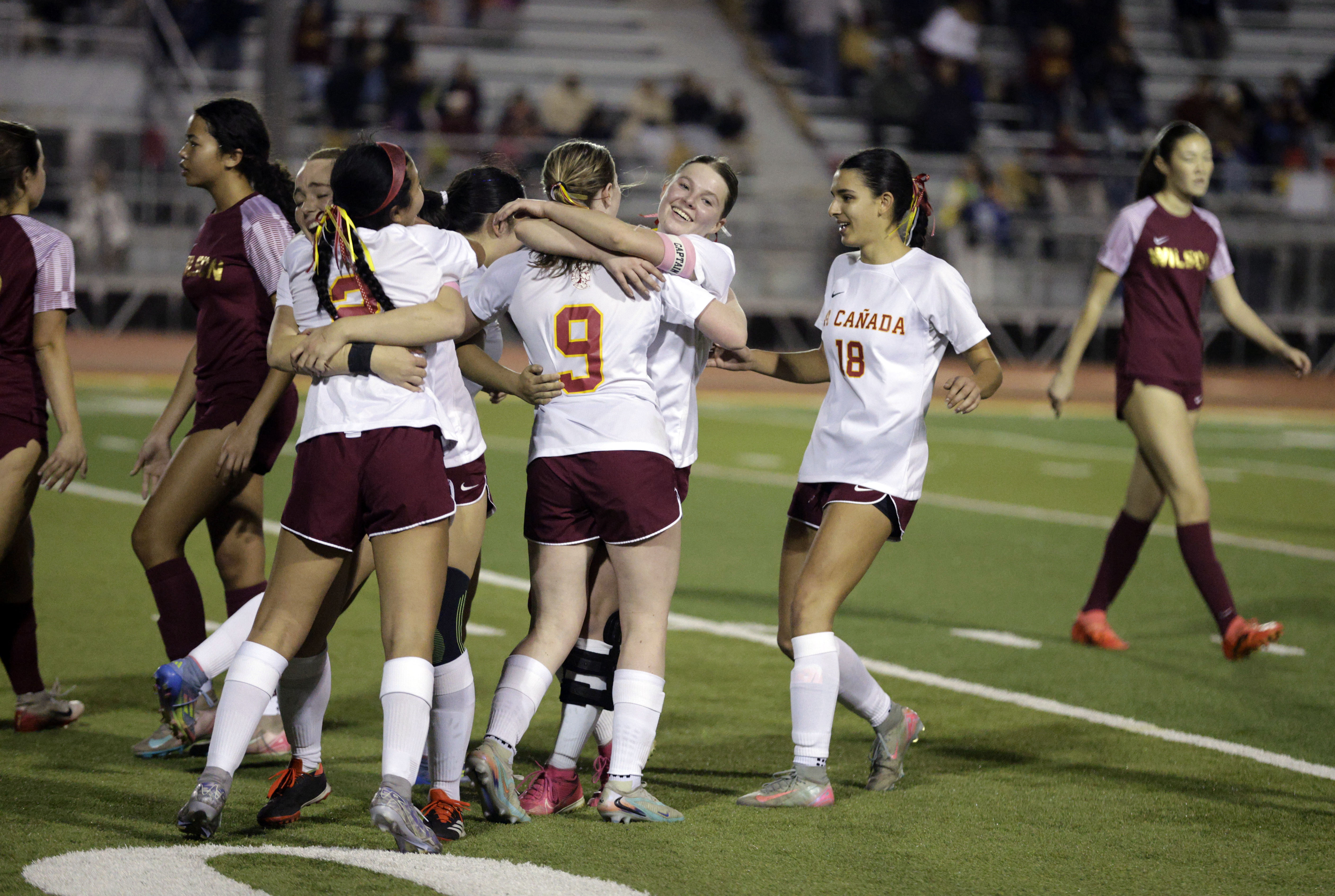 Players on the La Canada girls soccer team celebrate their...