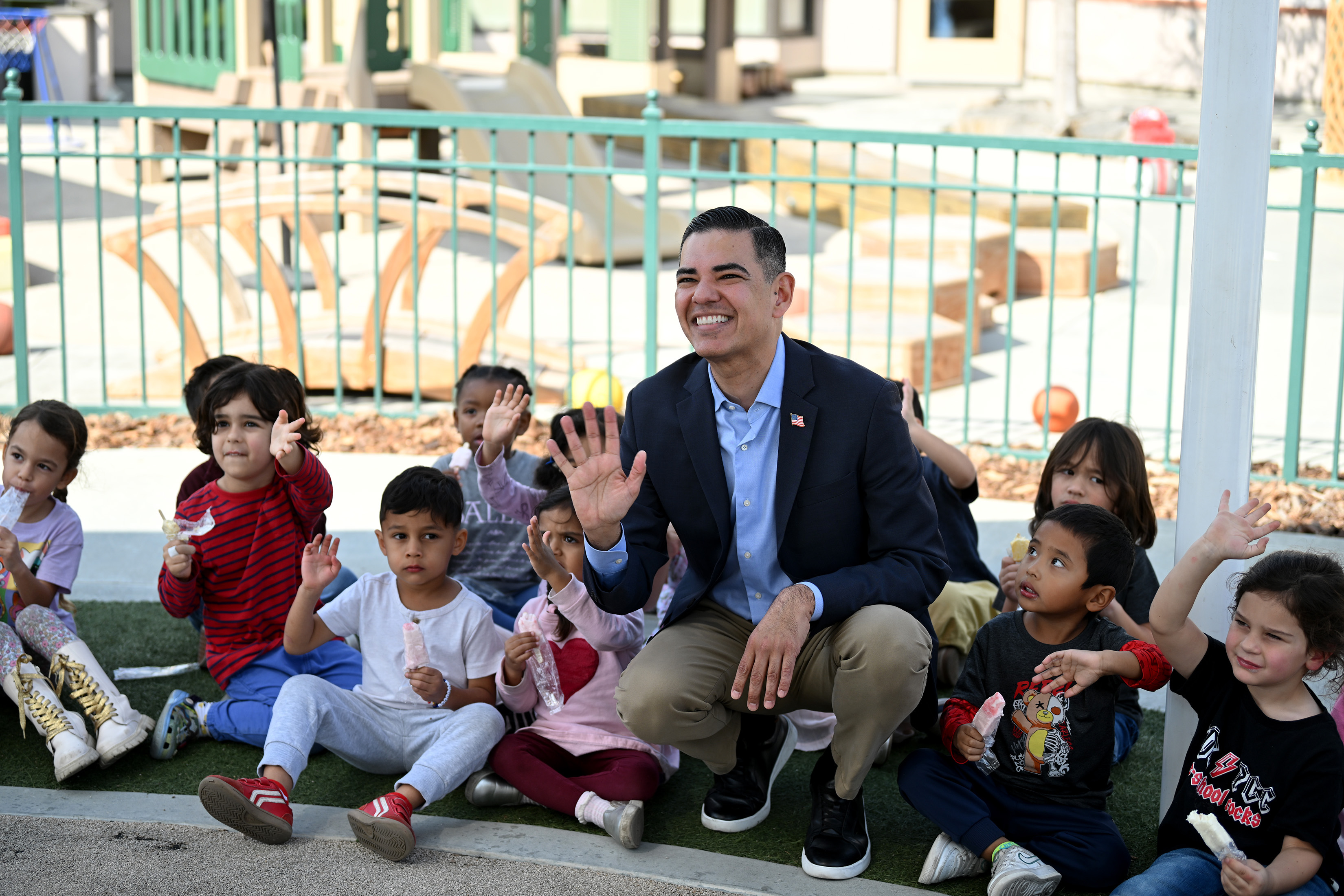 Congressman Robert Garcia poses for pictures with a group of...