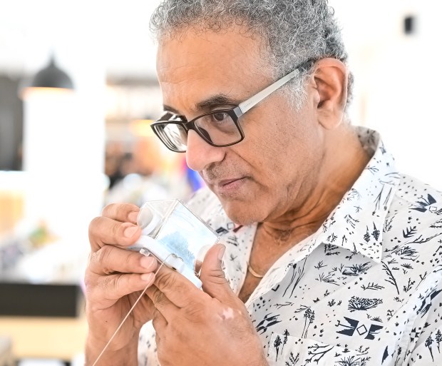 Laguna Woods resident Mayer Morchy sniffs pot contained in a clear plastic sensory pod with the press of a puff button at The Artist Tree cannabis dispensary, which opened in Laguna Woods on May 31, 2024.(Photo by Mark Rabinowitch, Contributing Photographer)