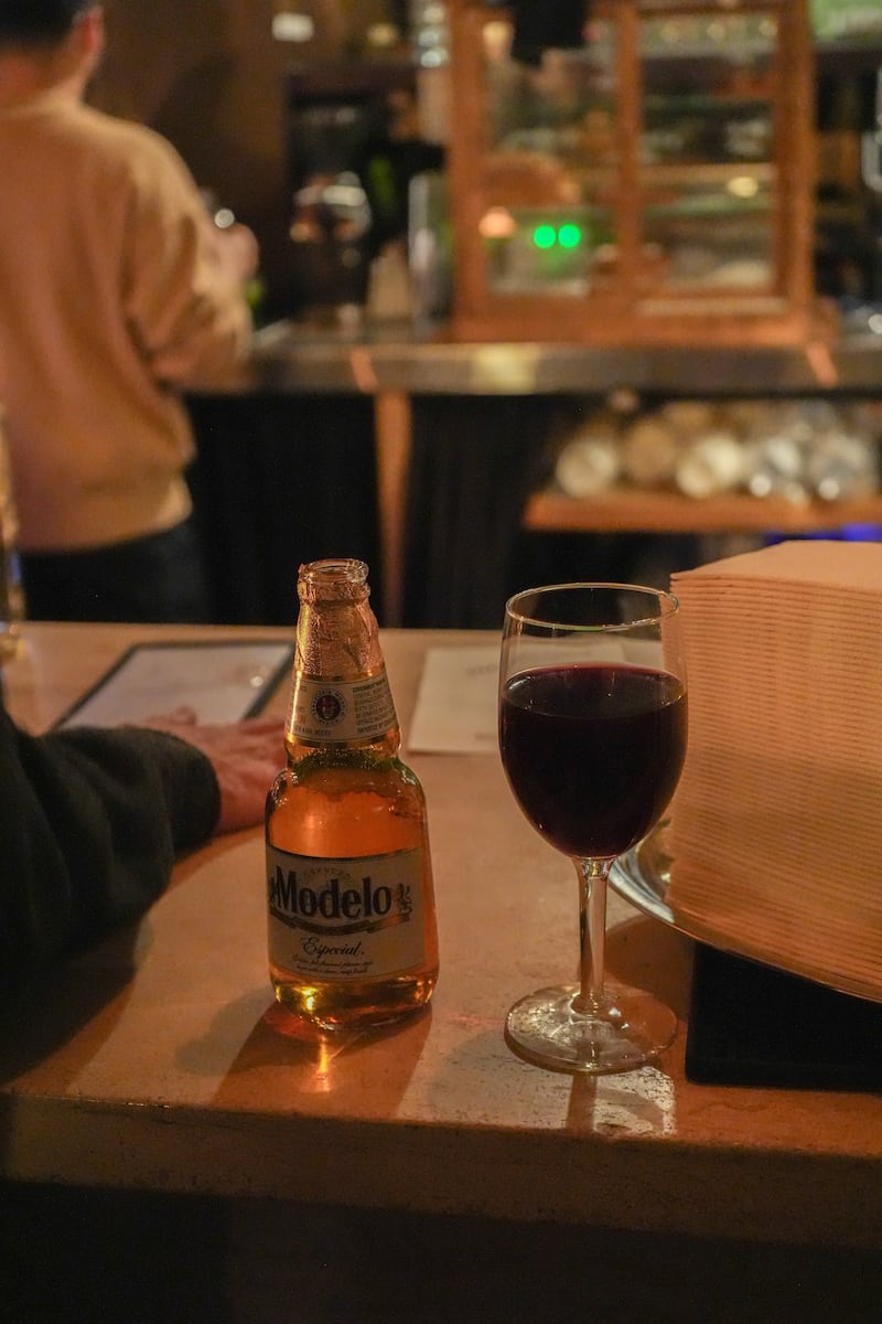Modelo beer and glass of red wine