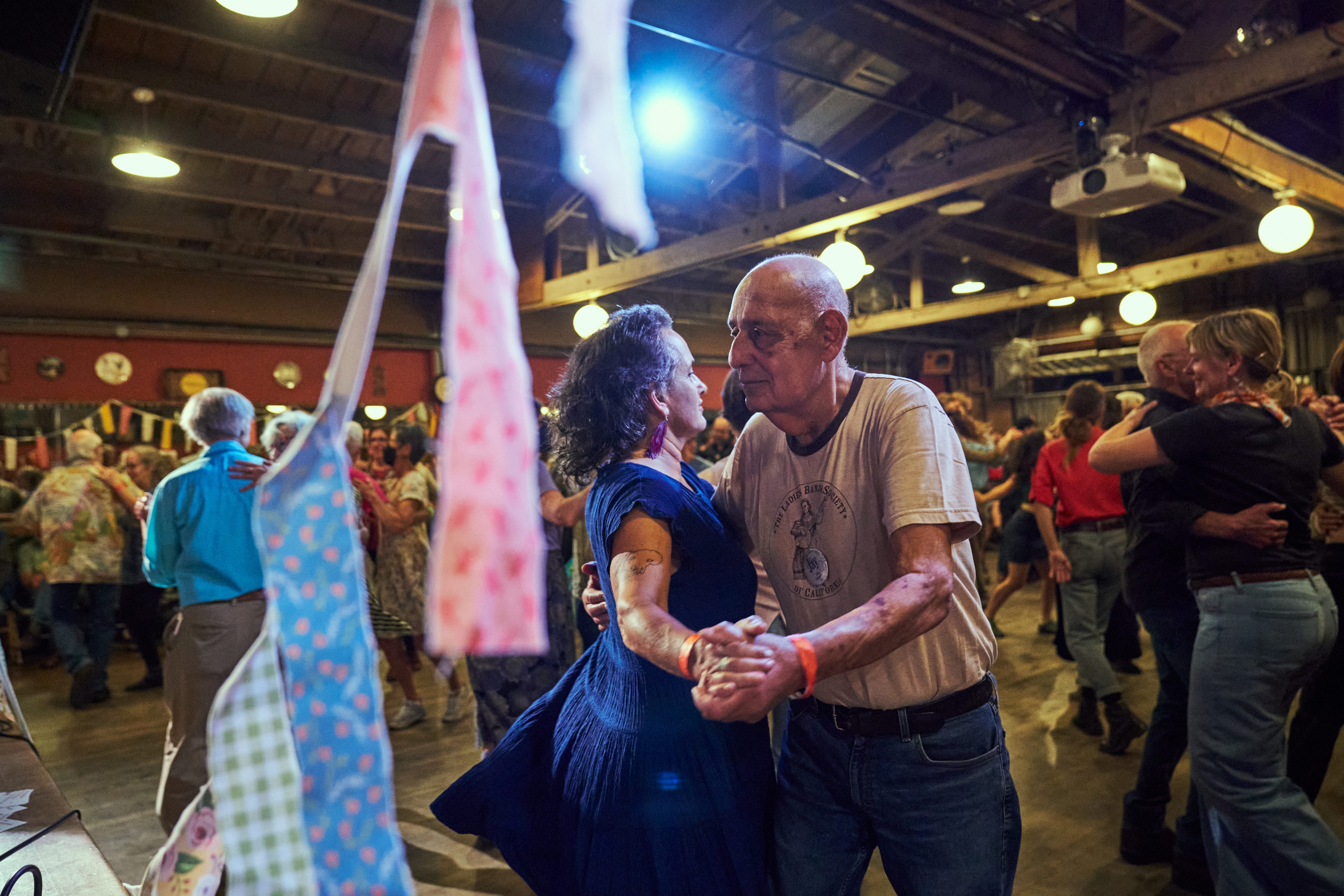 Organizer Evie Ladin, left, dances with her father Jay Ladin...