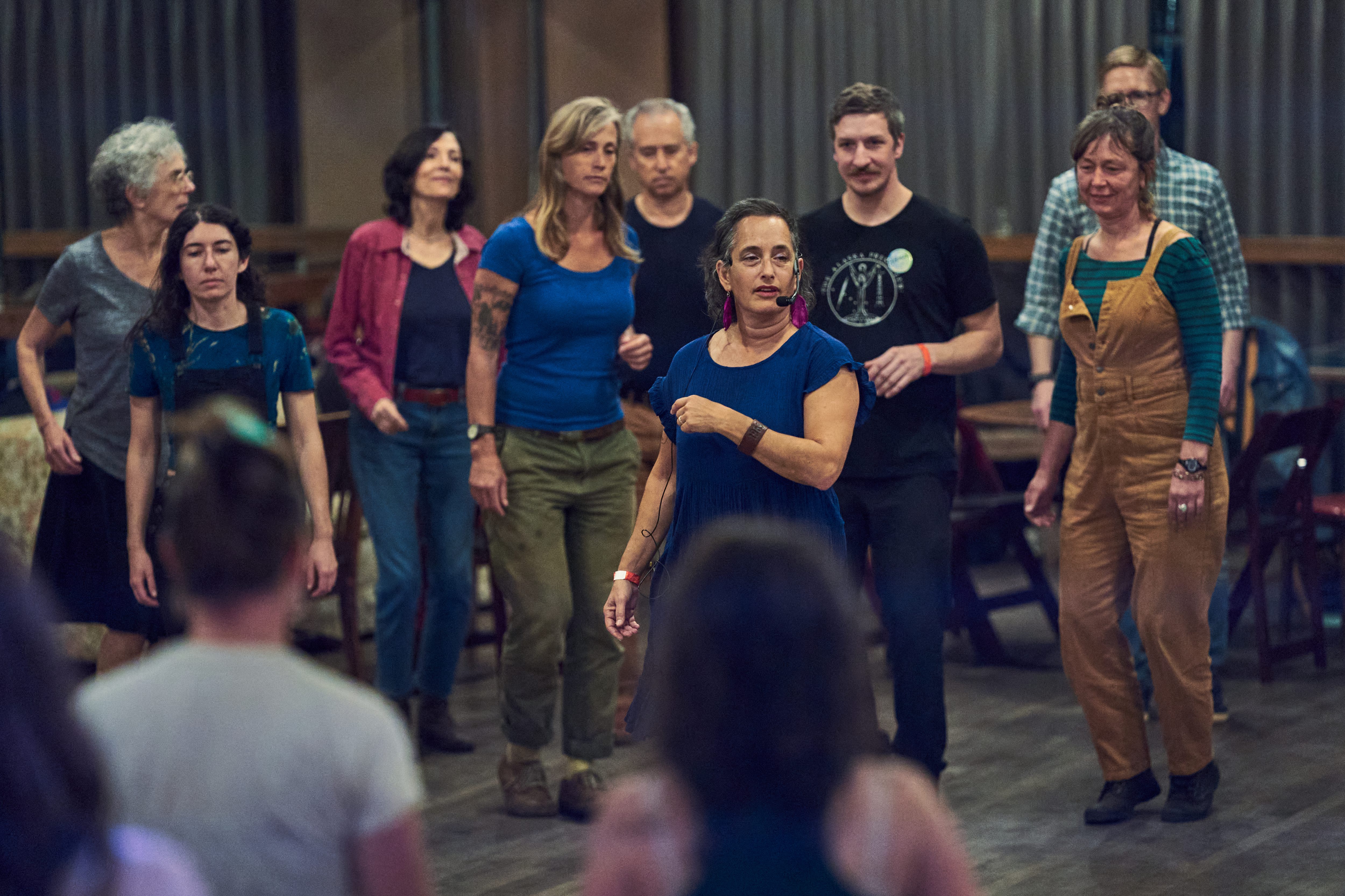 Organizer Evie Ladin, center, leads the clogging workshop during the...