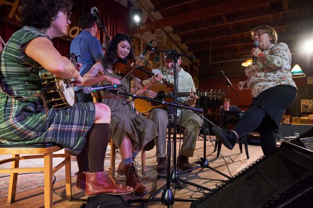 Caller Sue Hulsether, right, of Wisconsin interacts with Stumptown String Band from Portland, Ore., while giving directions to participants during the Dare to be Square festival at Ashkenaz Music and Dance Community Center in Berkeley, CA on Saturday, November 8, 2025. A popular form of dancing in the Bay Area, the festival brings people from all over the country. (Don Feria for Bay Area News Group)
