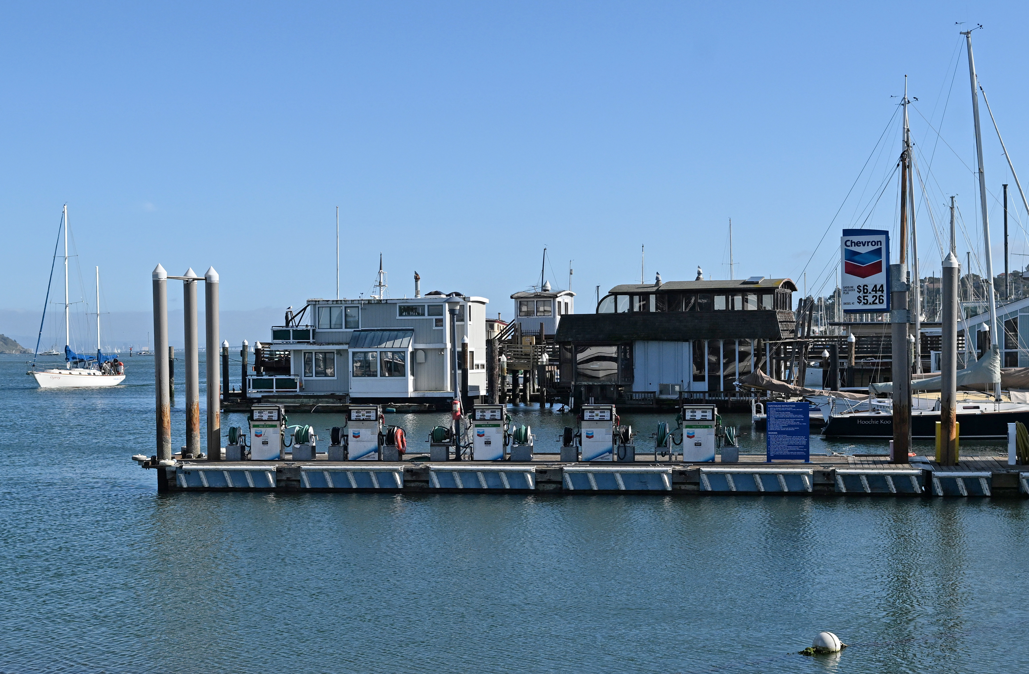 Floating homes stand beyond the Chevron fuel dock in the...