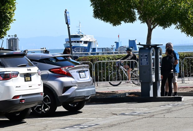 Drivers pay for parking at kiosks in the public lot near the ferry terminal in Sausalito, Calif., on Thursday, Sept. 28, 2023. (Sherry LaVars/Marin Independent Journal)