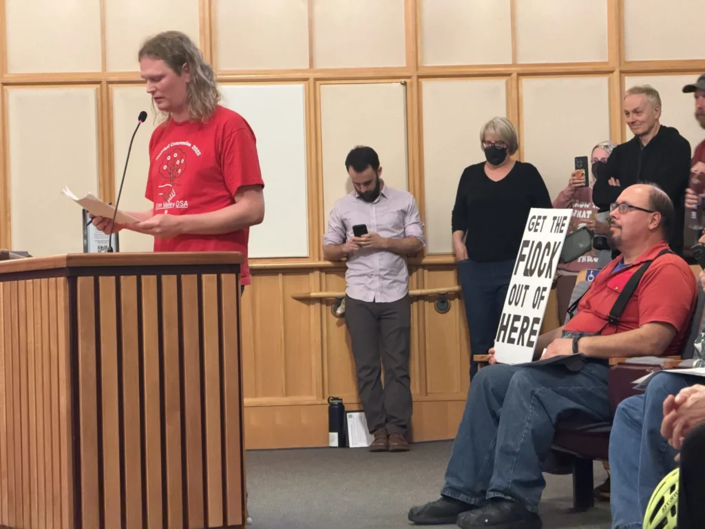 People stand at a government meeting in Mountain View, California