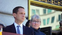 San Francisco Mayor Daniel Lurie stands alongside Helen Horvath on the steps of City Hall at a rally organized in support of Ken Jones.