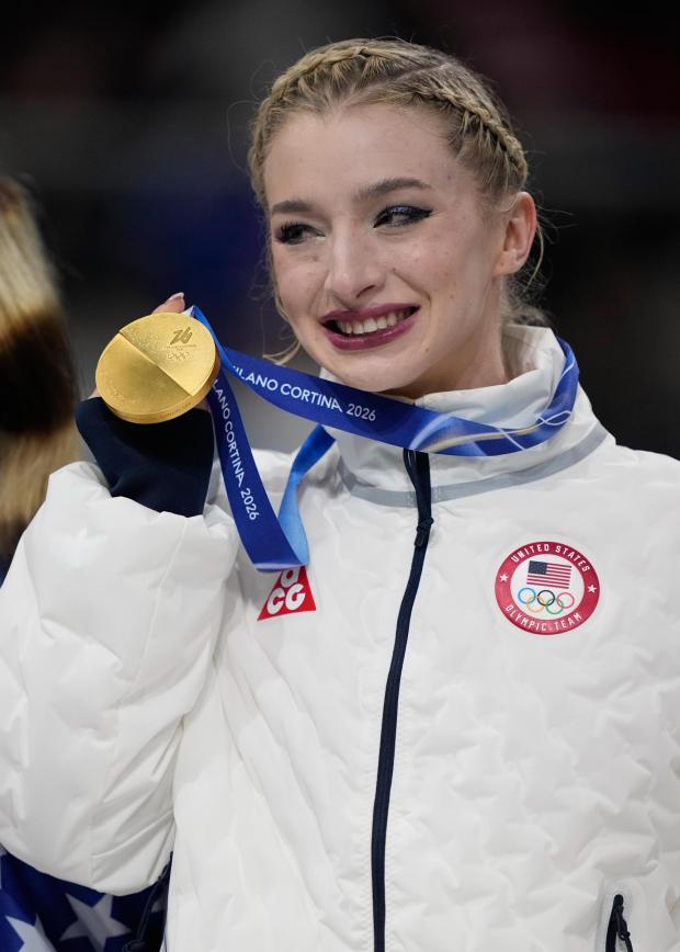Amber Glenn celebrates with her gold medal after the figure skating team event at the 2026 Winter Olympics, in Milan, Italy