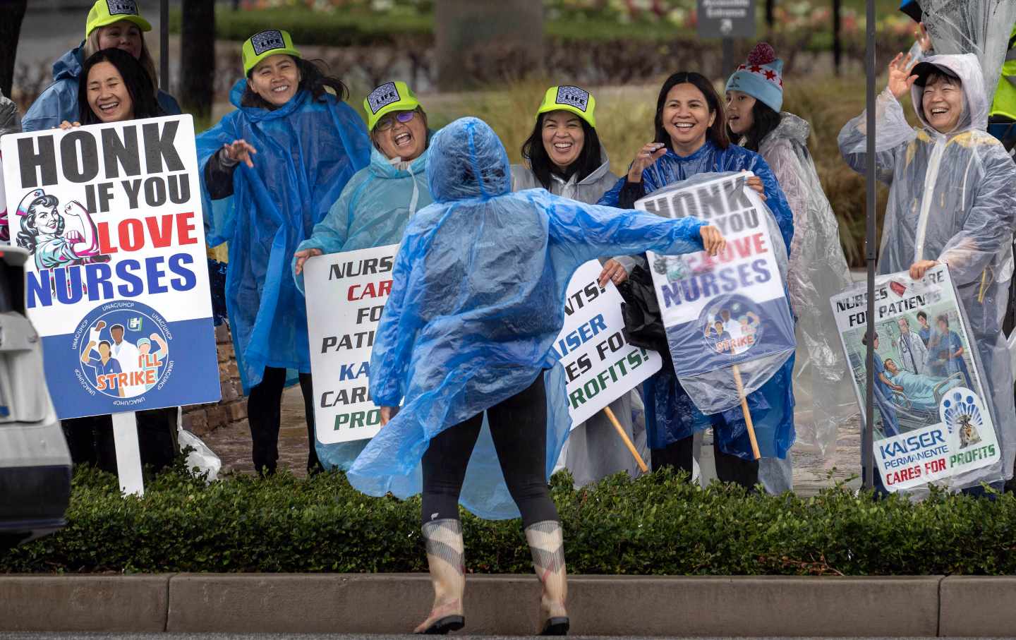 Striking Kaiser Permanente nurses and health care workers in the rain outside the Anaheim hospital, on February 16, 2026.